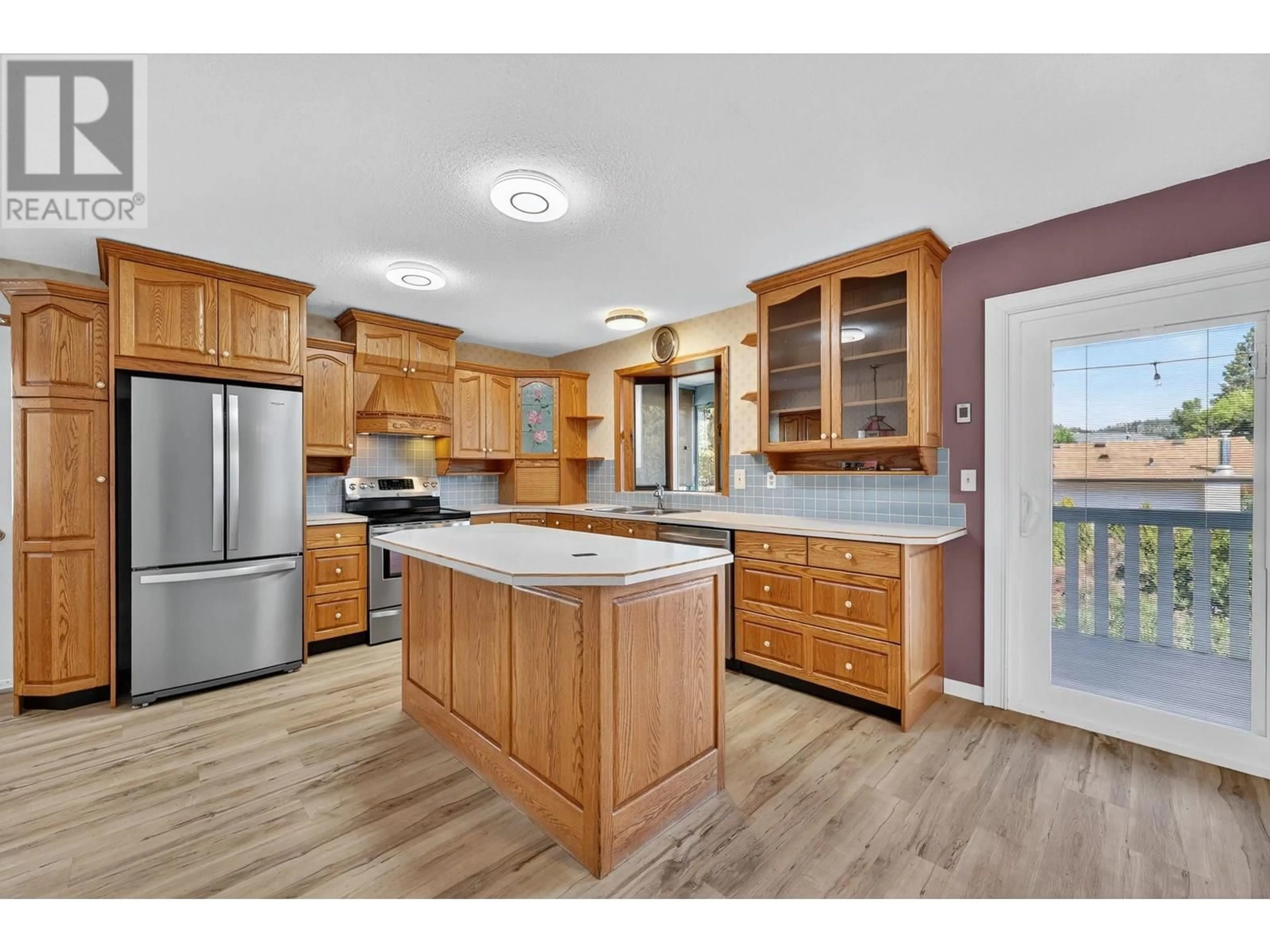 Open concept kitchen, wood/laminate floor for 1436 ATHANS COURT, Kelowna British Columbia V1Y8K3