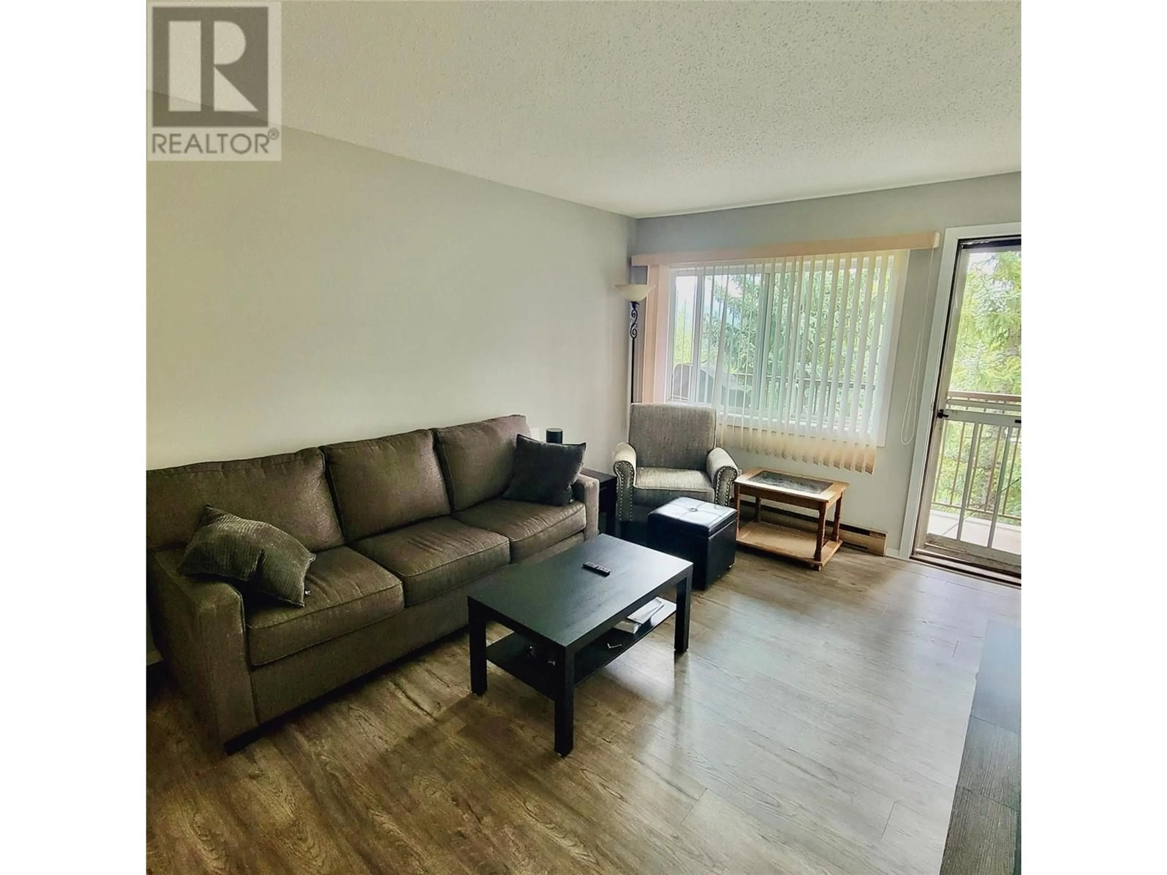 Living room with furniture, wood/laminate floor for 418 - 10 CARIBOO DRIVE, Elkford British Columbia V0B1H0