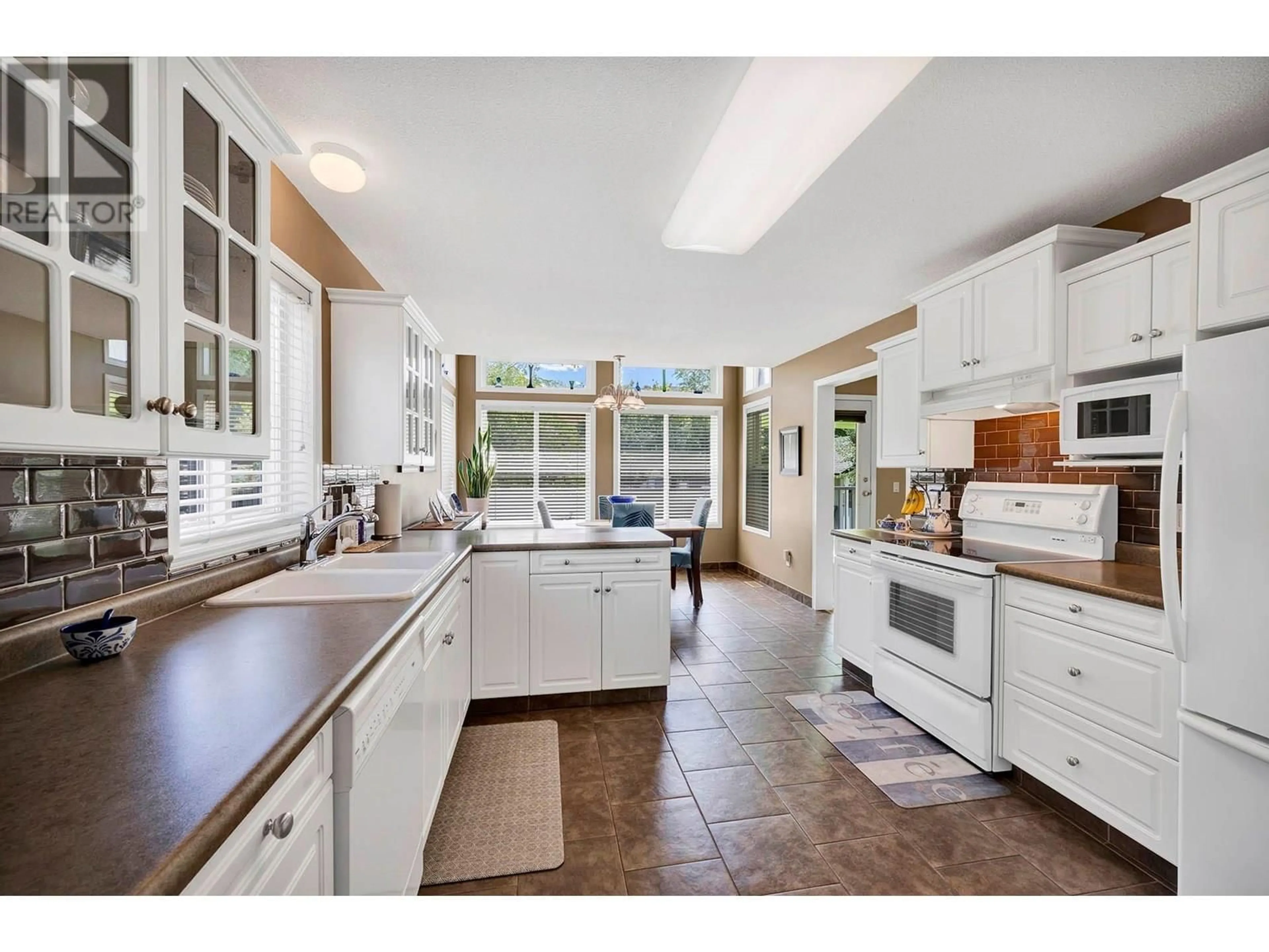 Open concept kitchen, ceramic/tile floor for 5800 TERN PLACE, Vernon British Columbia V1H1R2