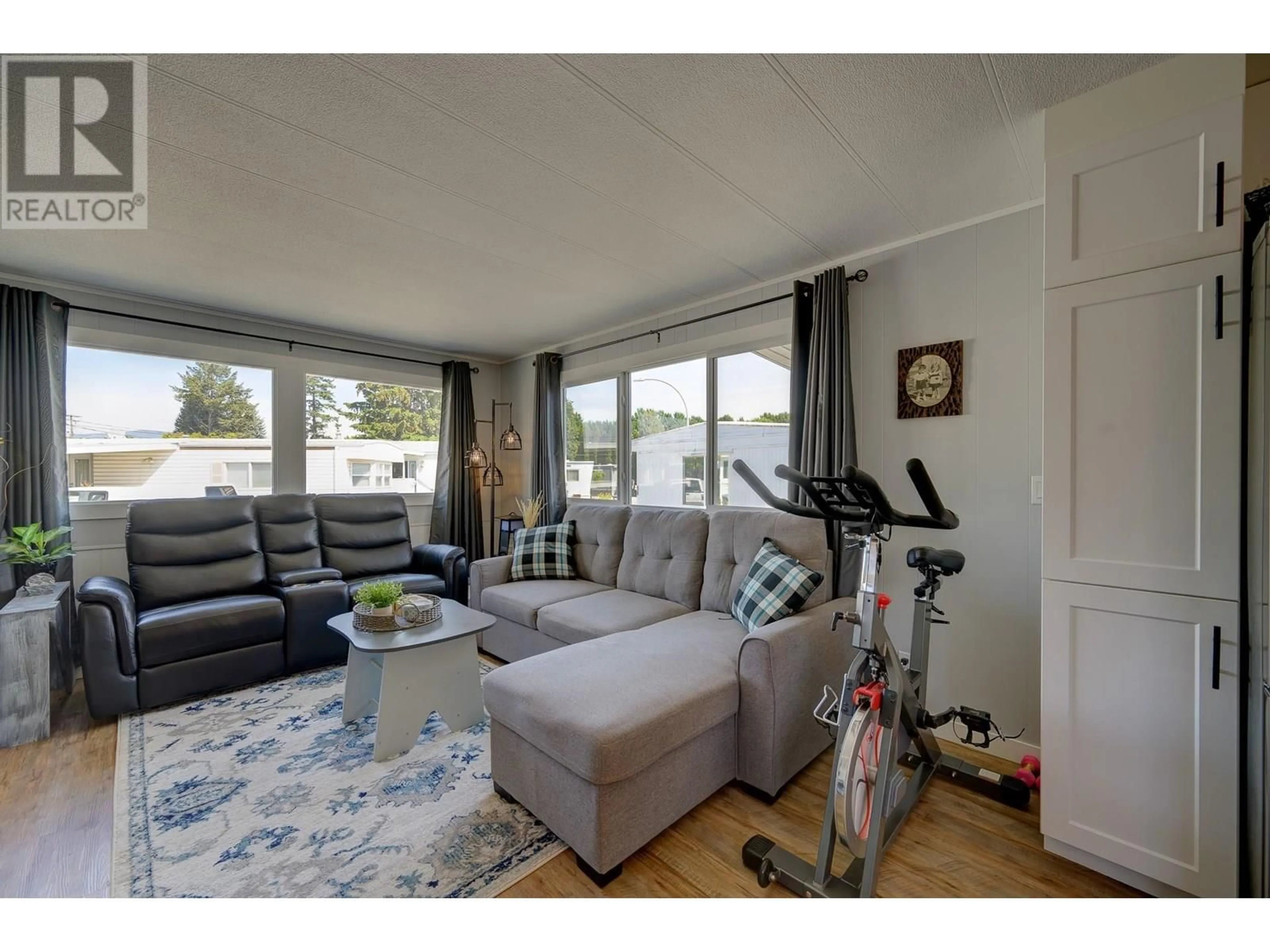 Living room with furniture, wood/laminate floor for 7 NEPTUNE DRIVE, Kamloops British Columbia V2B1A8