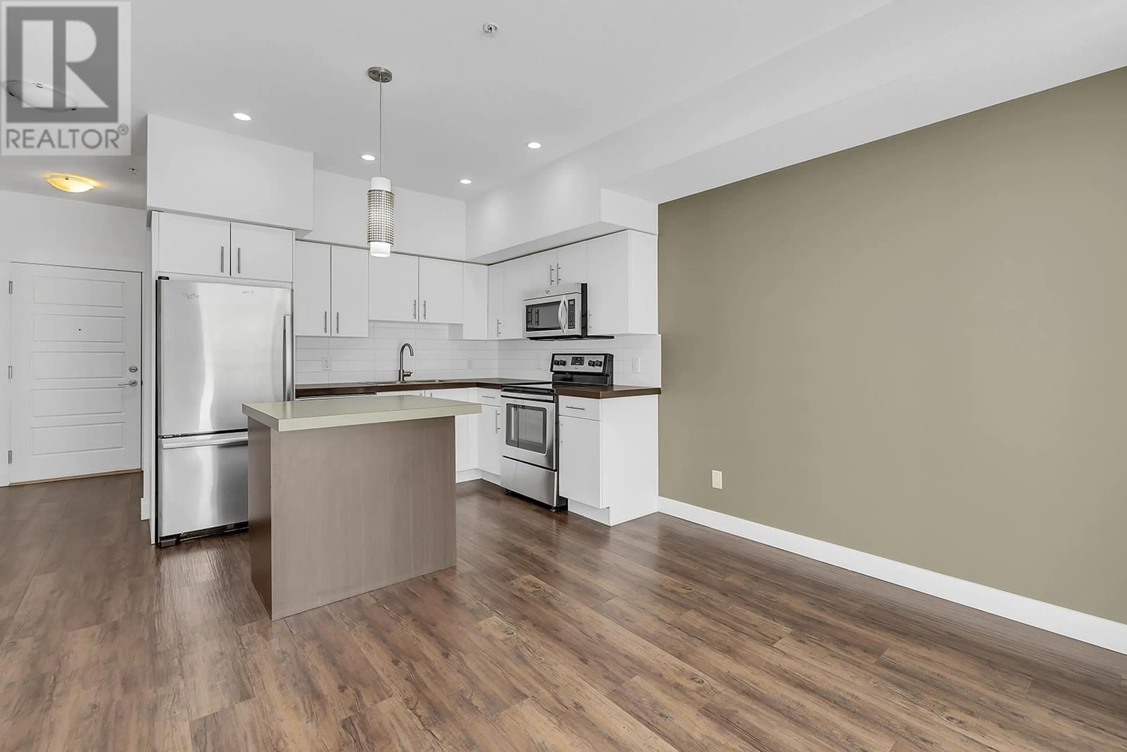 Open concept kitchen, wood/laminate floor for 210 - 975 ACADEMY WAY, Kelowna British Columbia V1V3C8