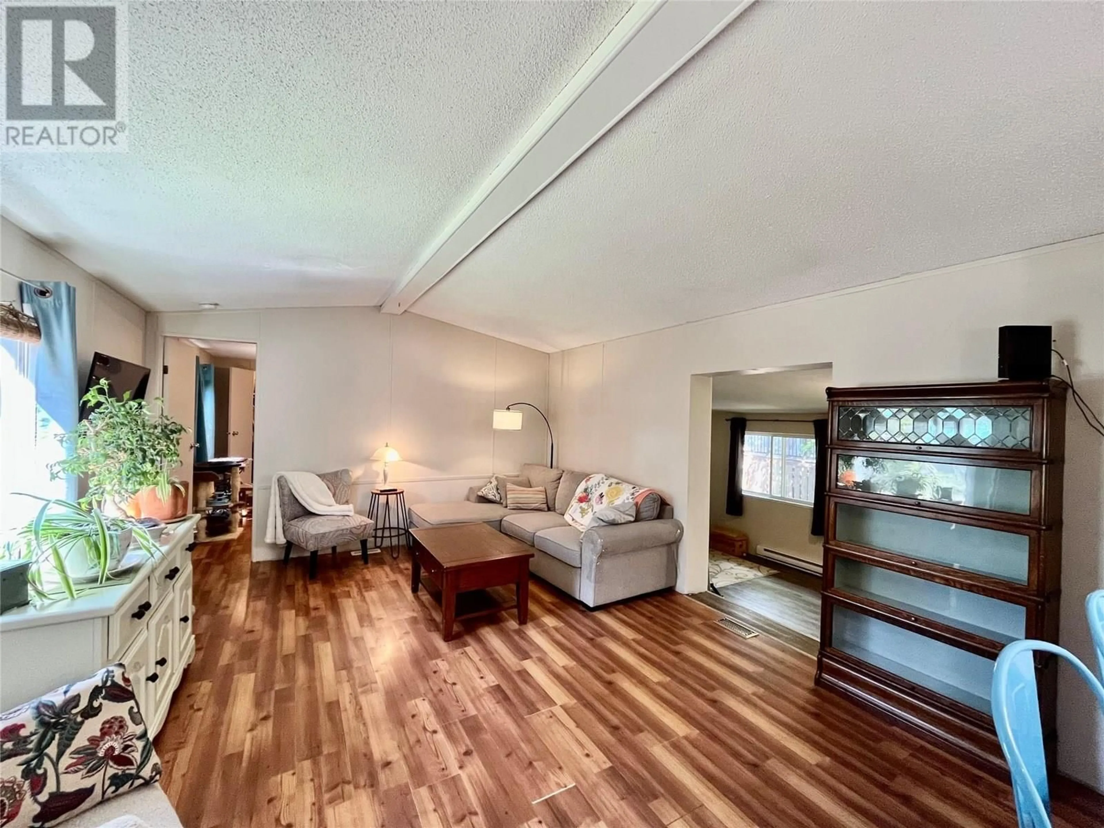Living room with furniture, wood/laminate floor for 833 COLUMBIA CRESCENT, Nakusp British Columbia V0G1R0