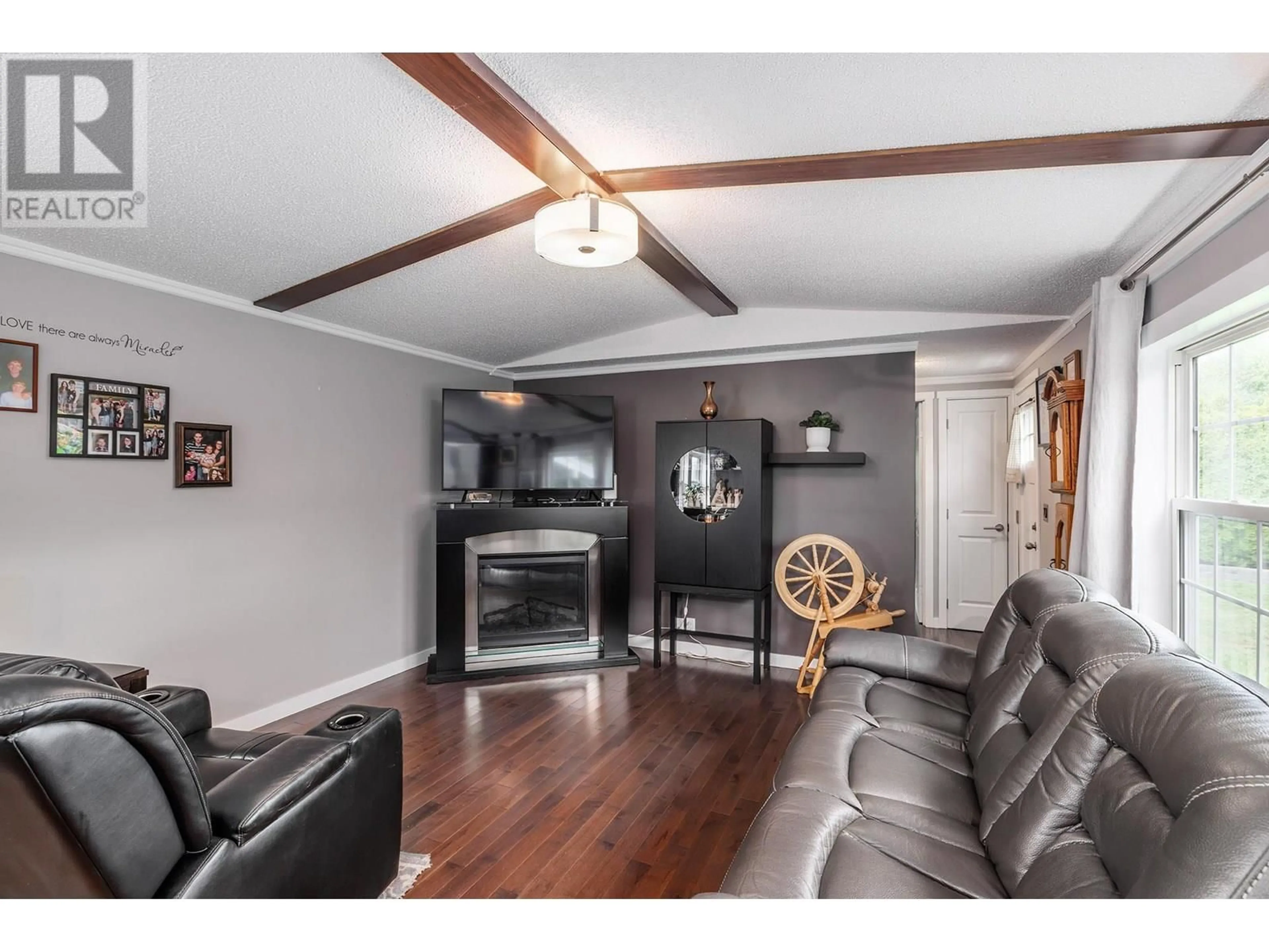 Living room with furniture, wood/laminate floor for 70 - 3381 VILLAGE GREEN WAY, Westbank British Columbia V4T1L2