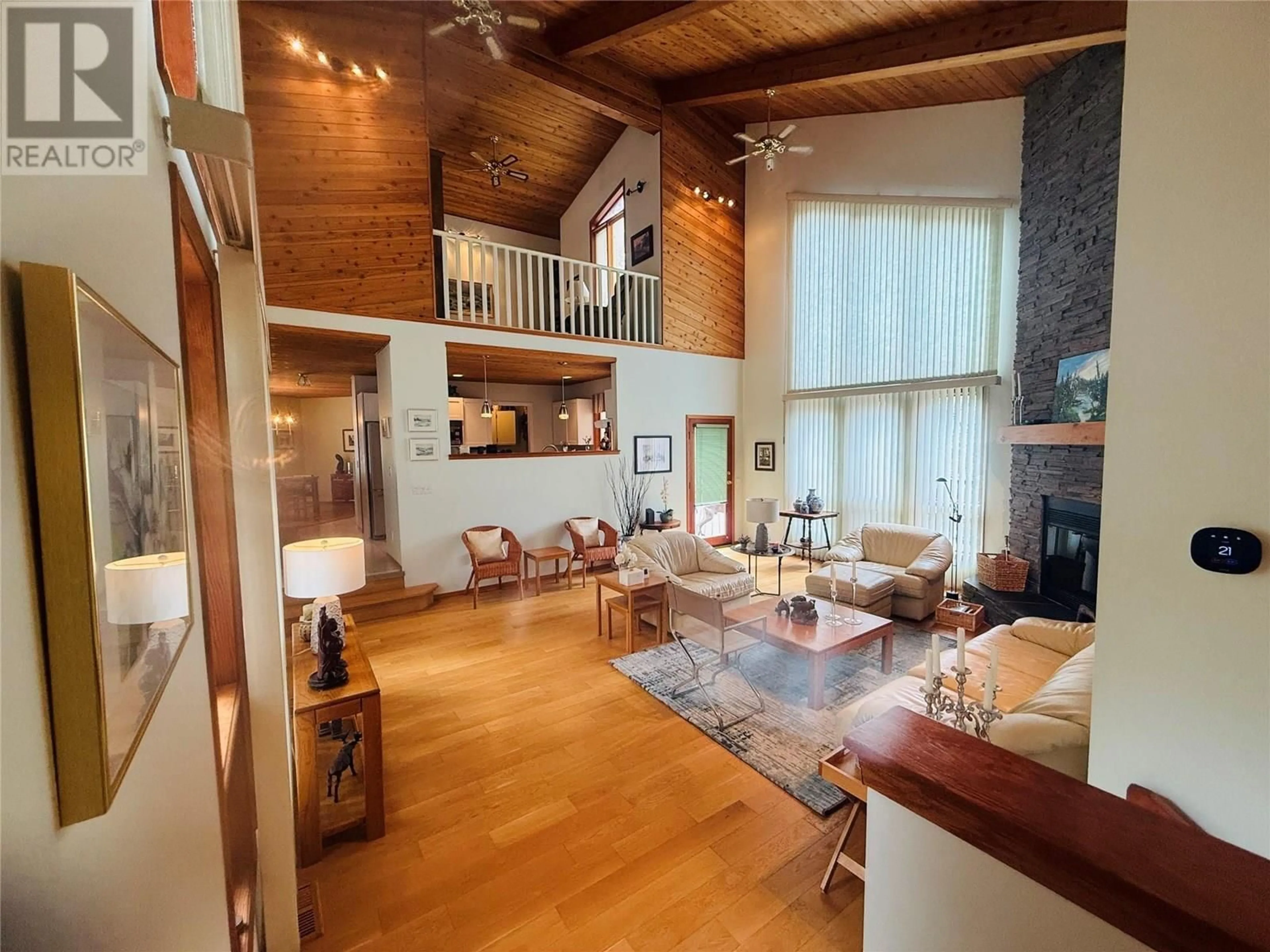 Living room with furniture, wood/laminate floor for 5221 COLUMBIA RIVER ROAD, Fairmont Hot Springs British Columbia V0B1L1