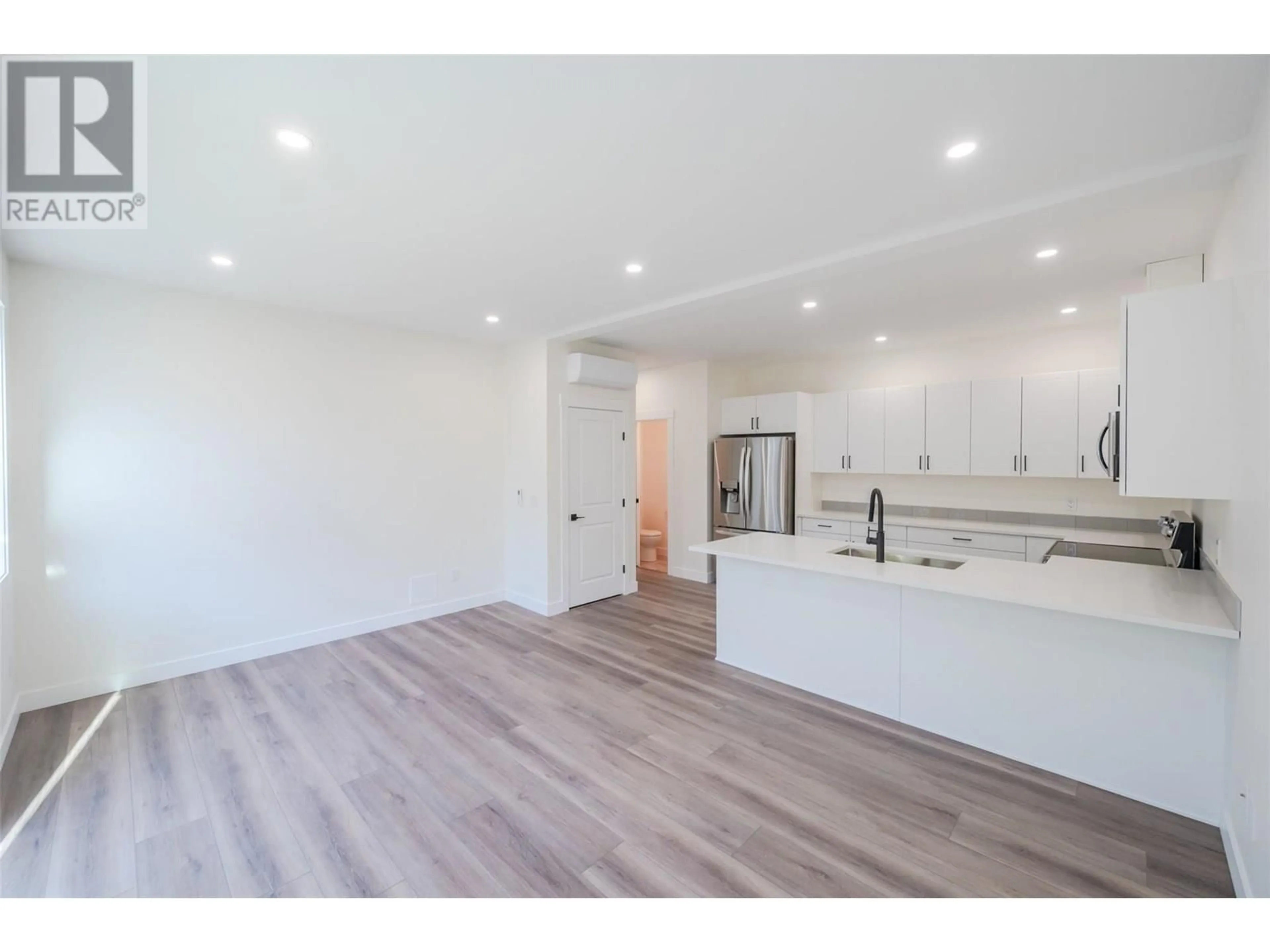Open concept kitchen, wood/laminate floor for 101 - 11612 VICTORIA ROAD SOUTH, Summerland British Columbia V0H1Z2