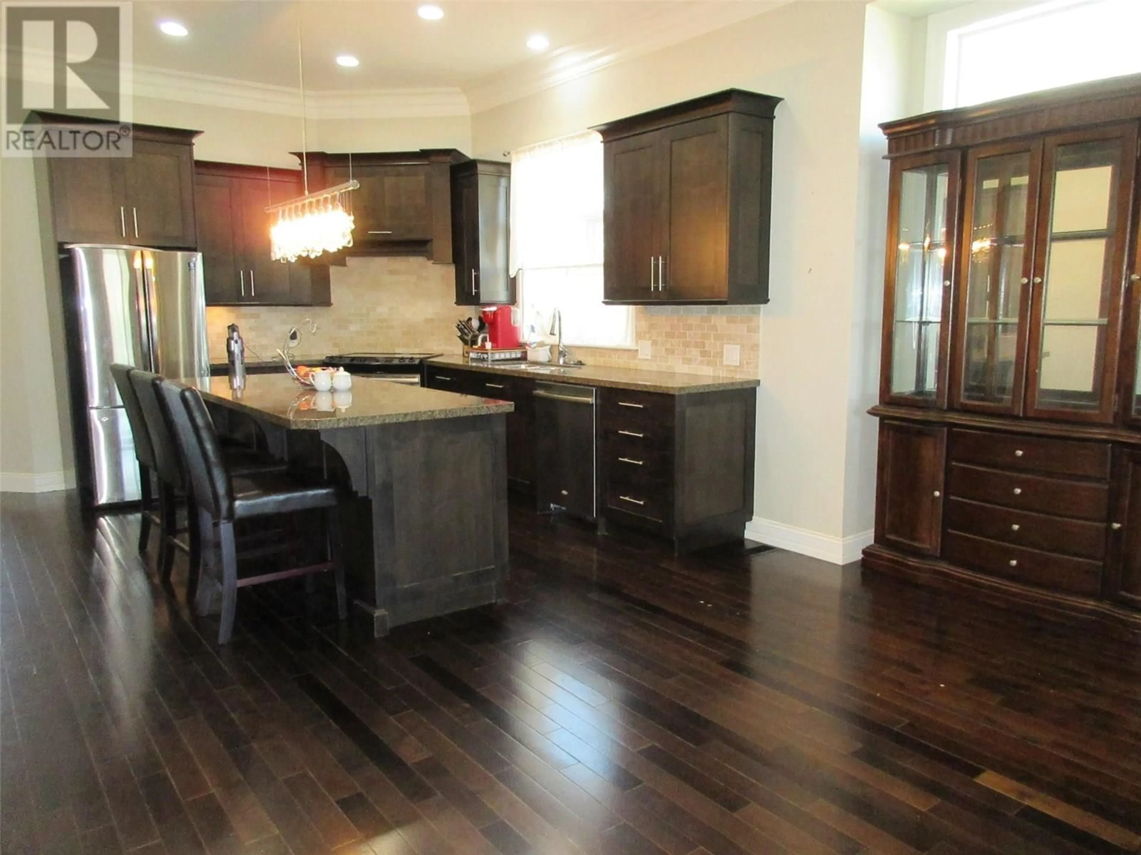 Open concept kitchen, wood/laminate floor for 3043 HILTON DRIVE, Merritt British Columbia V1K0B2