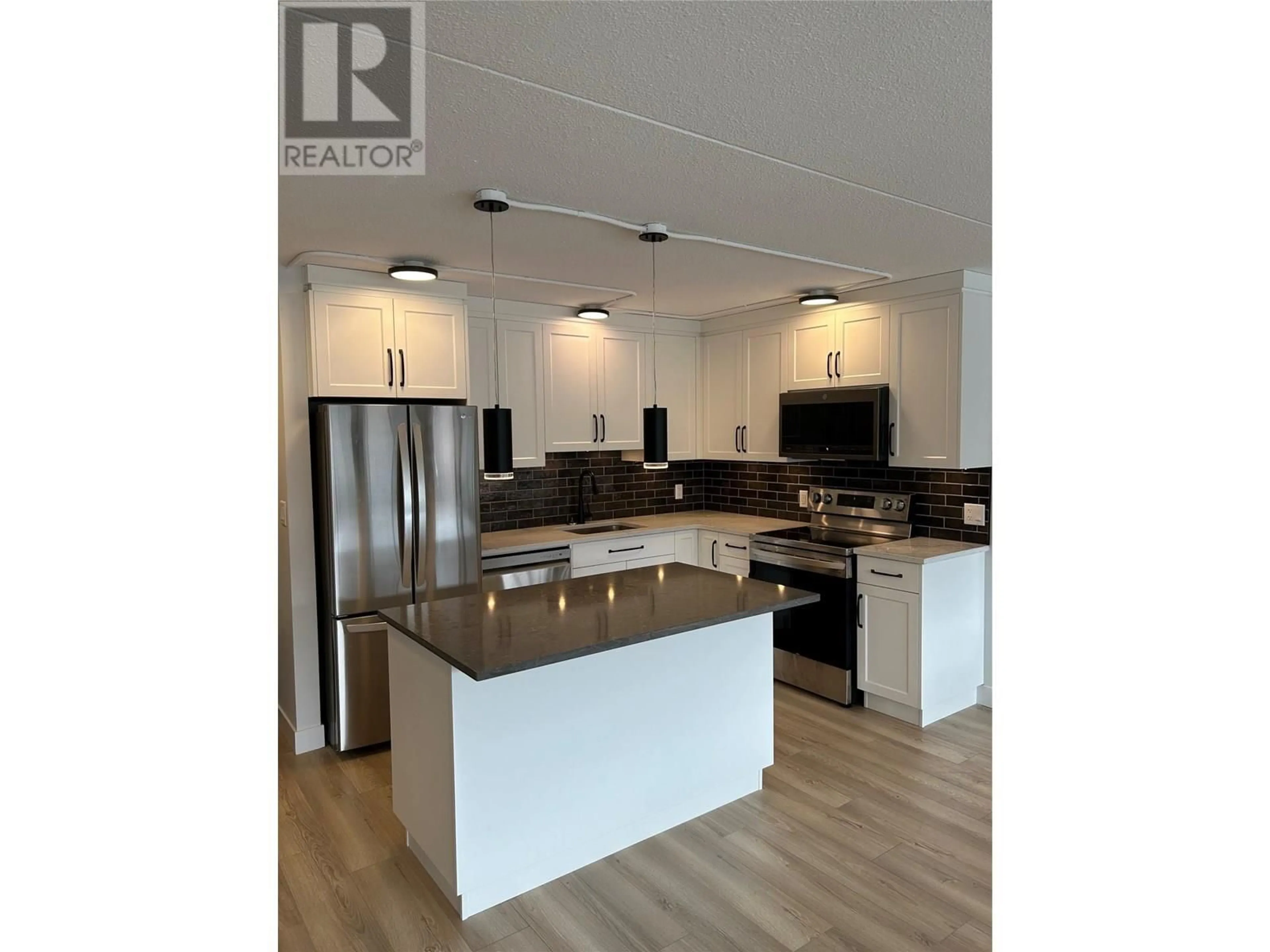 Open concept kitchen, wood/laminate floor for 403 - 525 NICOLA STREET, Kamloops British Columbia V2C6J5