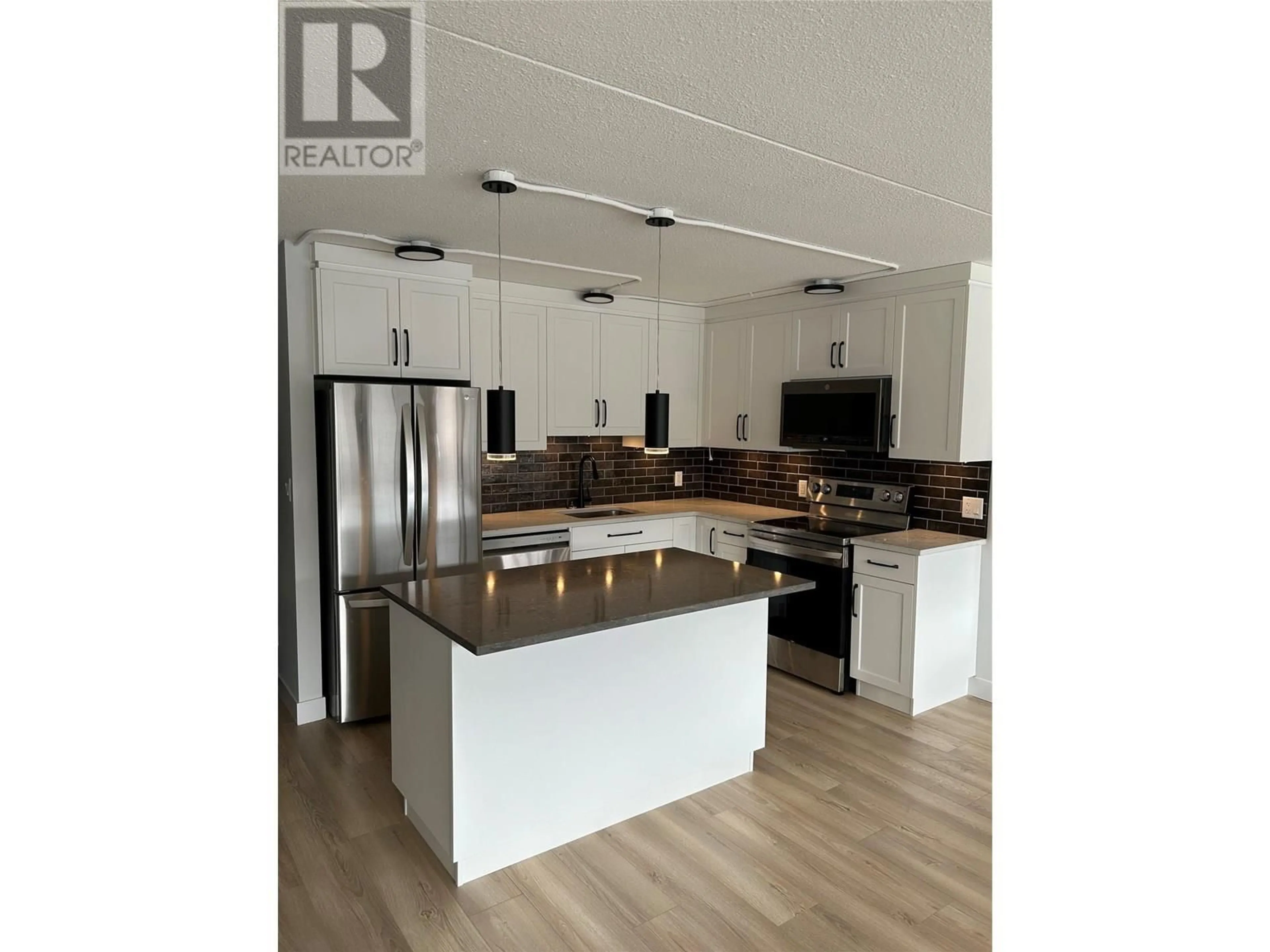 Open concept kitchen, wood/laminate floor for 403 - 525 NICOLA STREET, Kamloops British Columbia V2C6J5