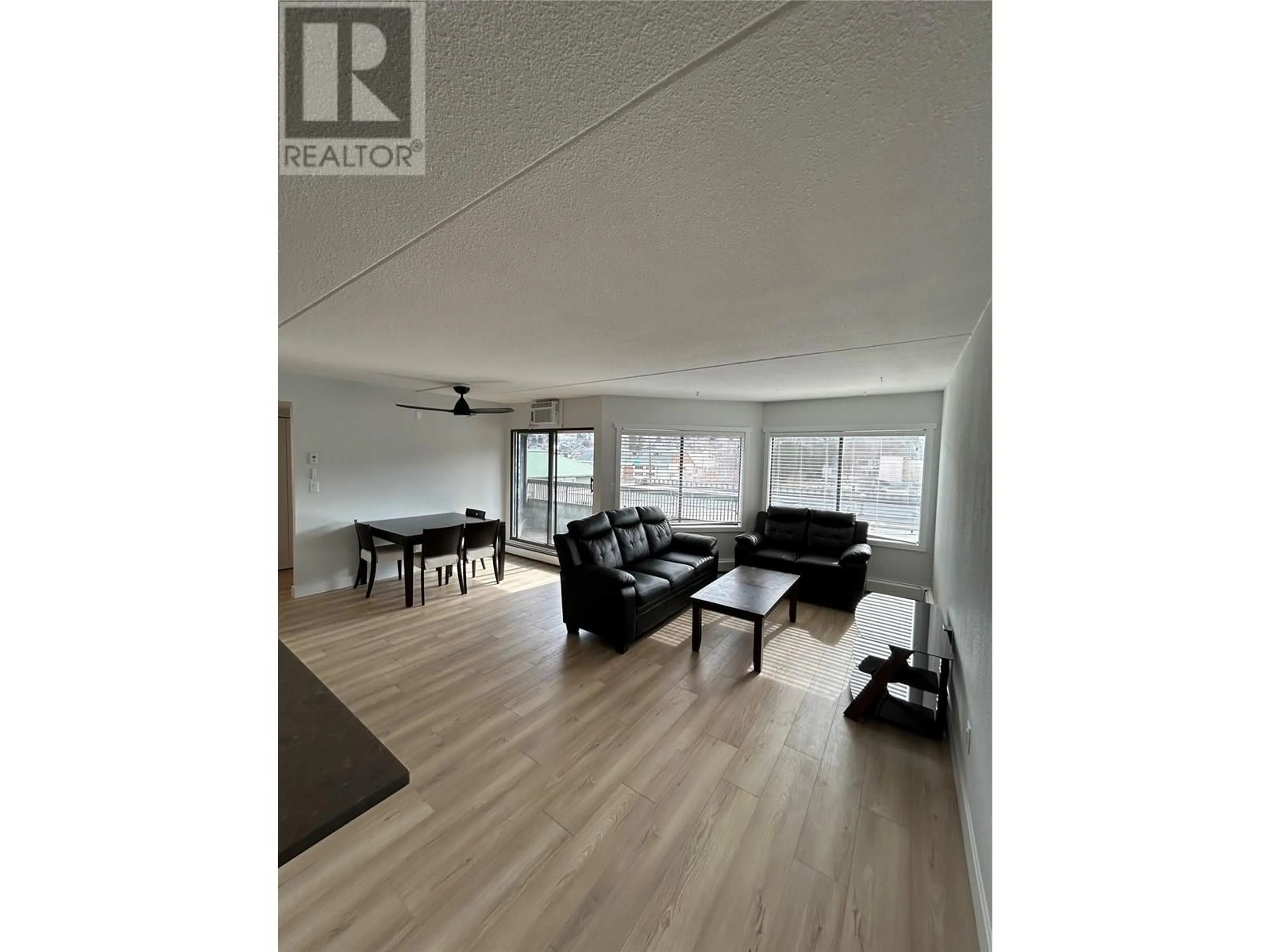 Living room with furniture, wood/laminate floor for 403 - 525 NICOLA STREET, Kamloops British Columbia V2C6J5