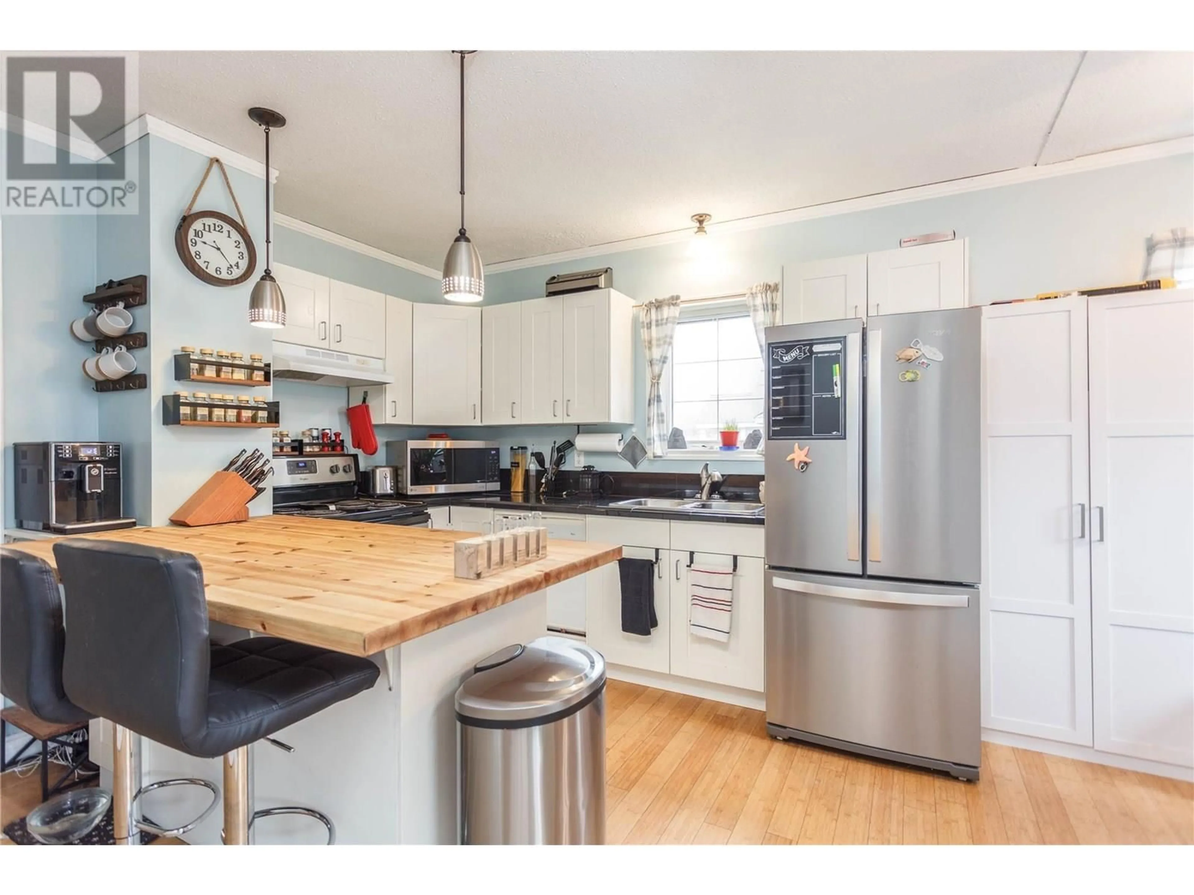 Open concept kitchen, wood/laminate floor for 728 MILL AVENUE, Enderby British Columbia V0E1V0