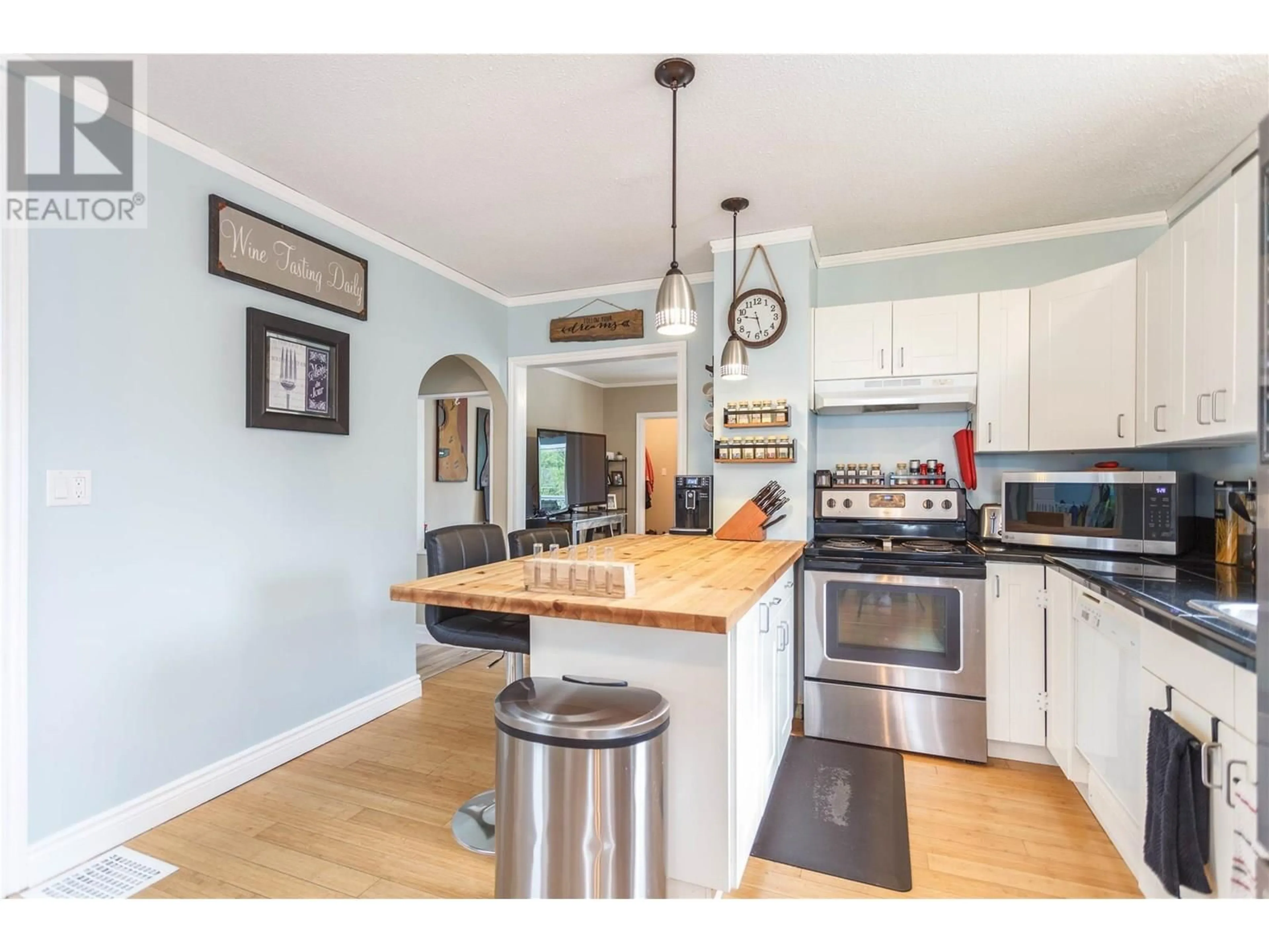 Open concept kitchen, wood/laminate floor for 728 MILL AVENUE, Enderby British Columbia V0E1V0