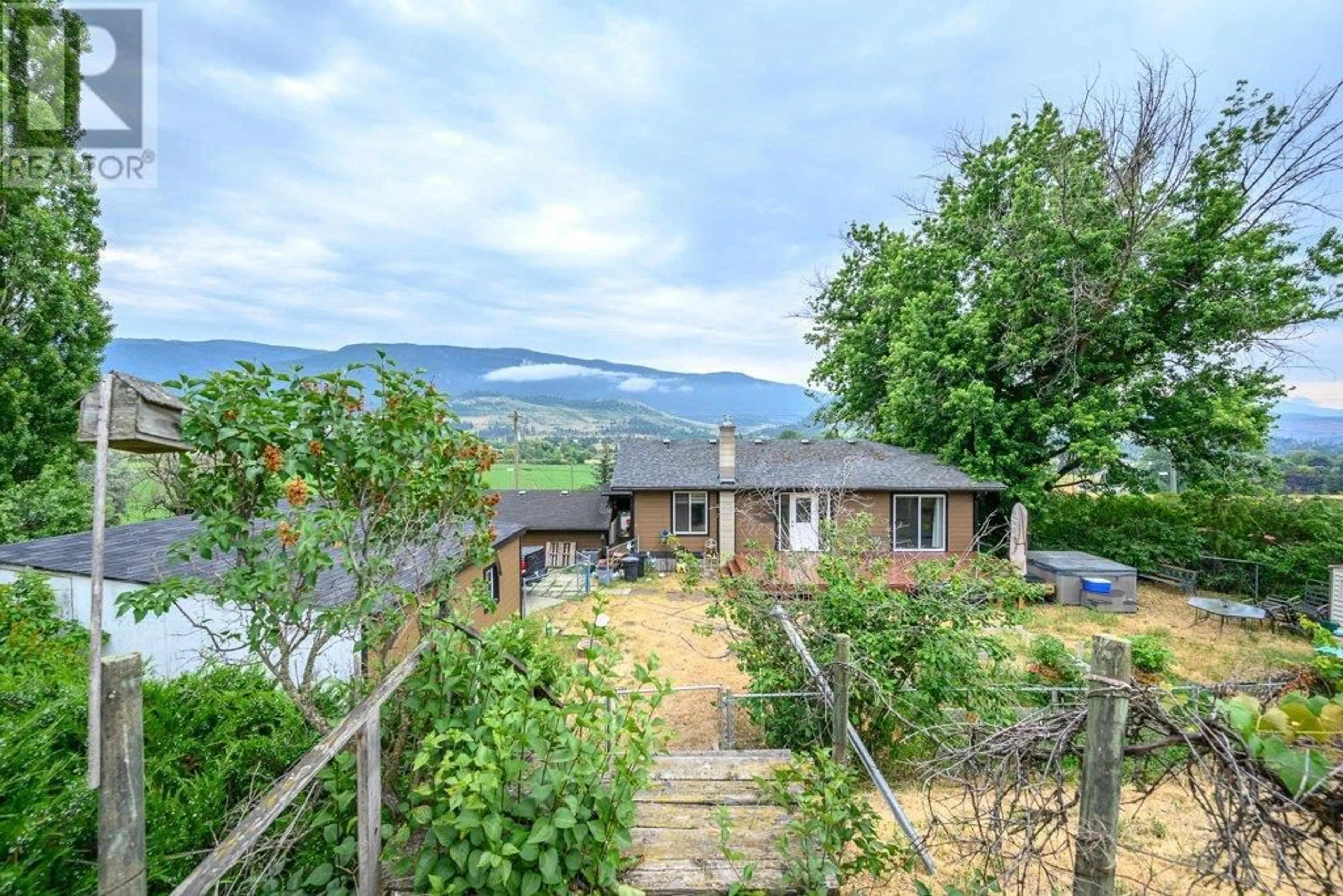 A pic from outside/outdoor area/front of a property/back of a property/a pic from drone, mountain view for 9221 6 HIGHWAY, Coldstream British Columbia V1B3B5