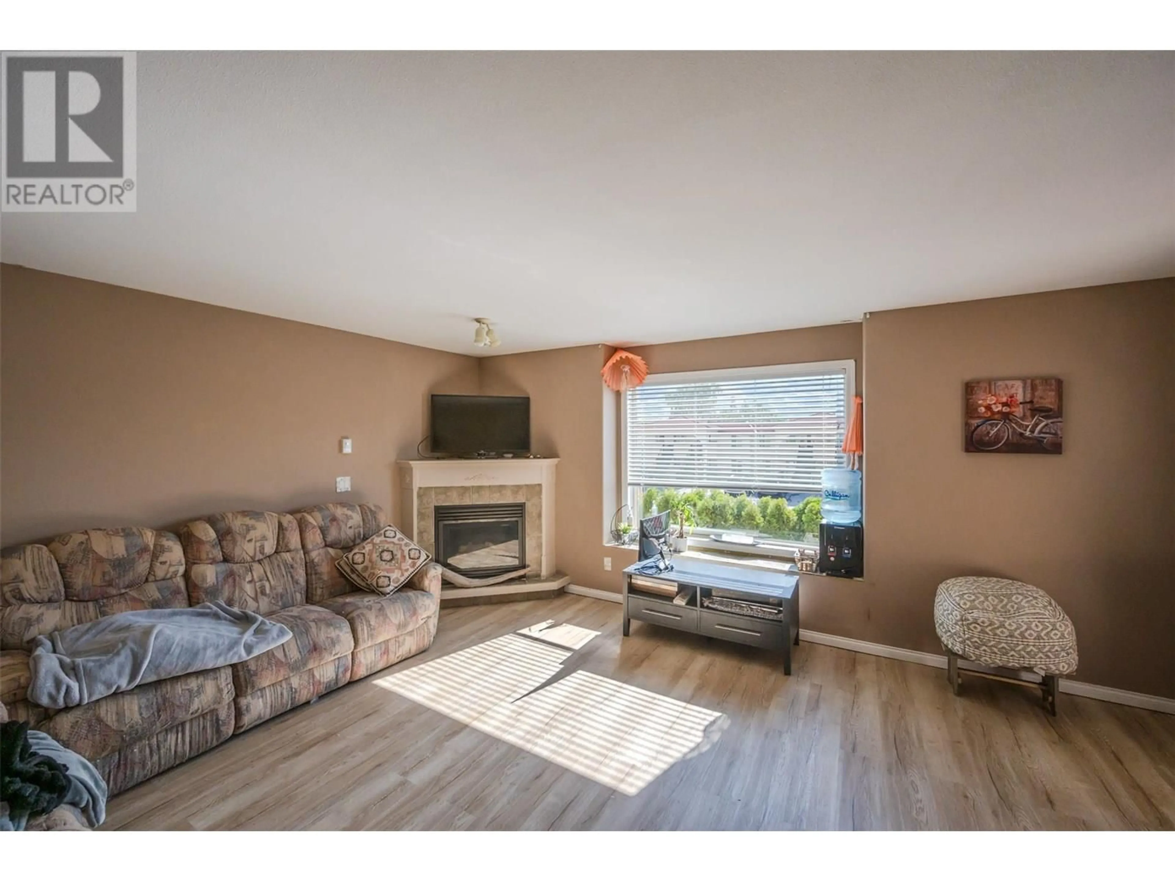 Living room with furniture, wood/laminate floor for 213 - 9307 62ND AVENUE, Osoyoos British Columbia V0H1V1