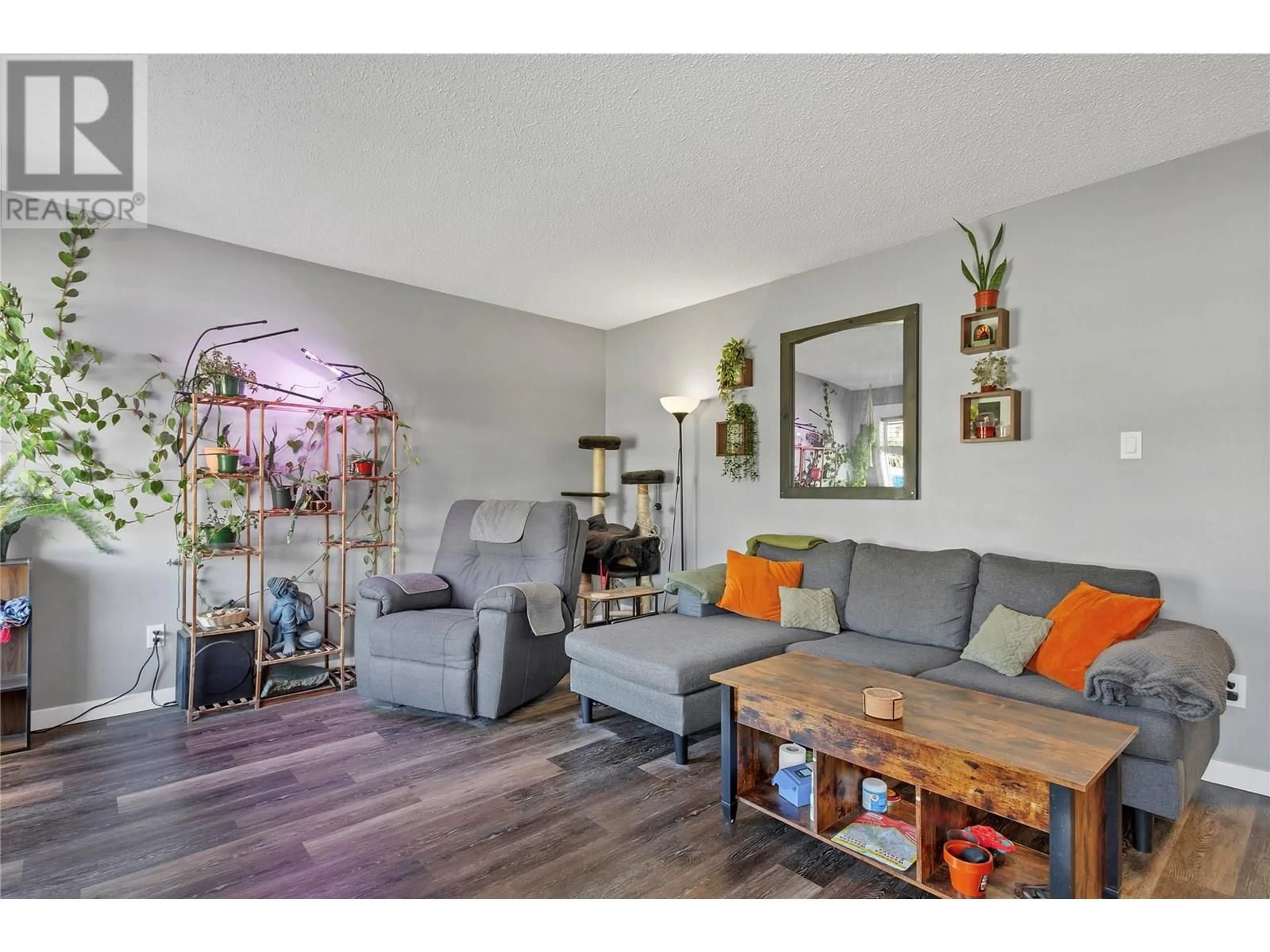 Living room with furniture, wood/laminate floor for 4808 25 AVENUE, Vernon British Columbia V1T6R4