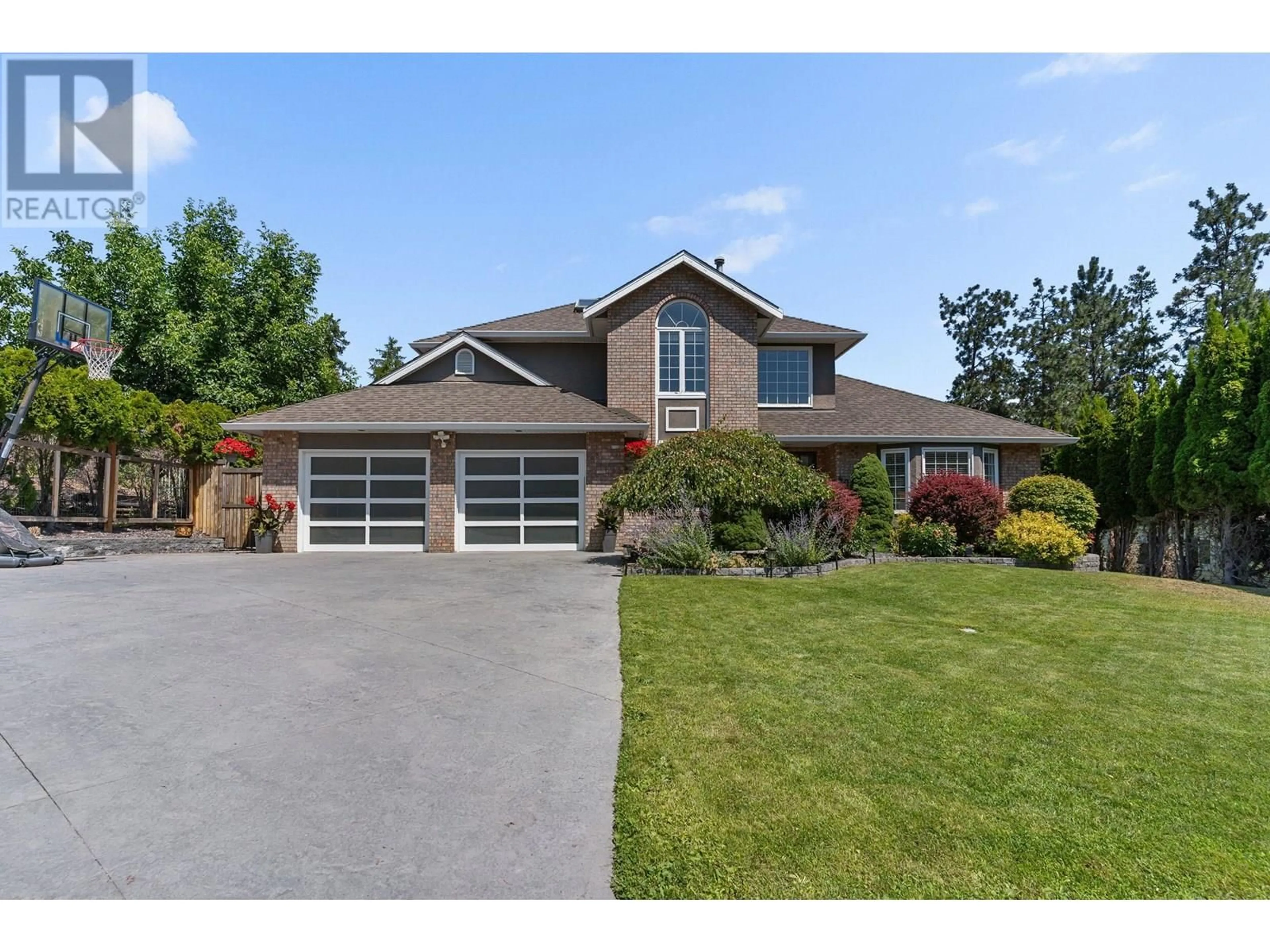 Home with brick exterior material, street for 409 CURLEW DRIVE, Kelowna British Columbia V1W4L3