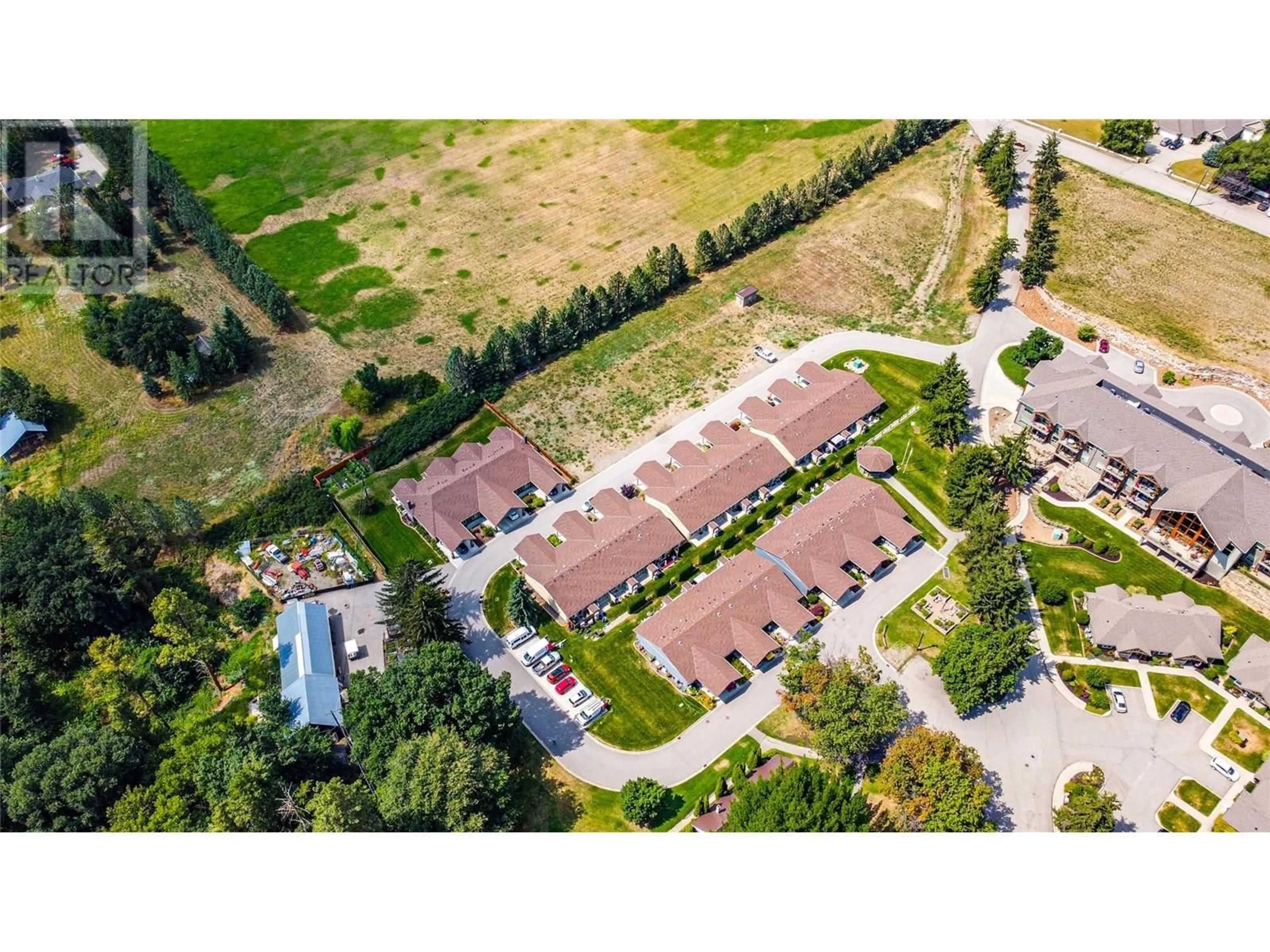A pic from outside/outdoor area/front of a property/back of a property/a pic from drone, street for 37-42 - 9108 MACKIE DRIVE, Coldstream British Columbia V1B1G9