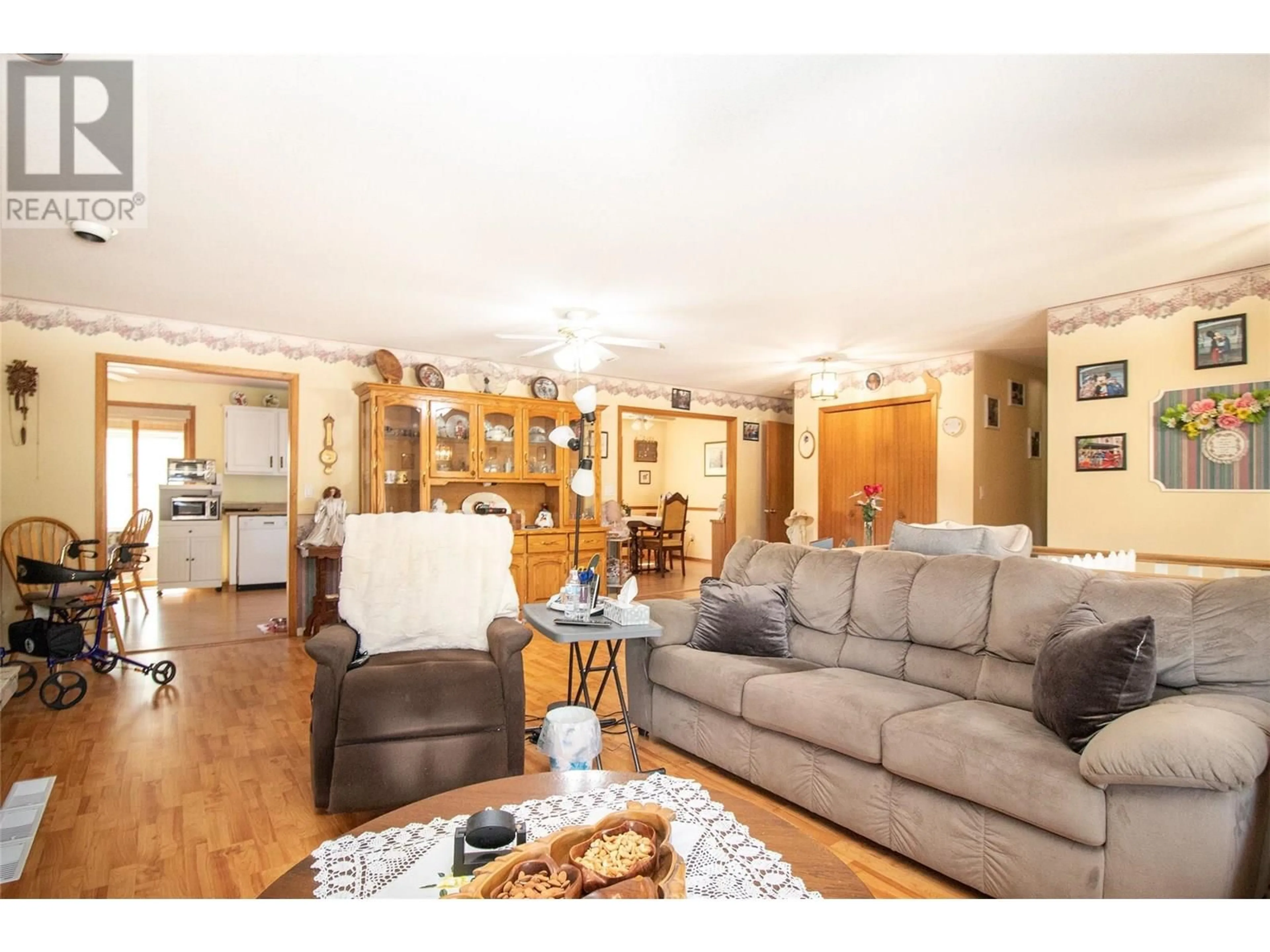 Living room with furniture, wood/laminate floor for 460 DOUGALL ROAD SOUTH, Kelowna British Columbia V1X3J8