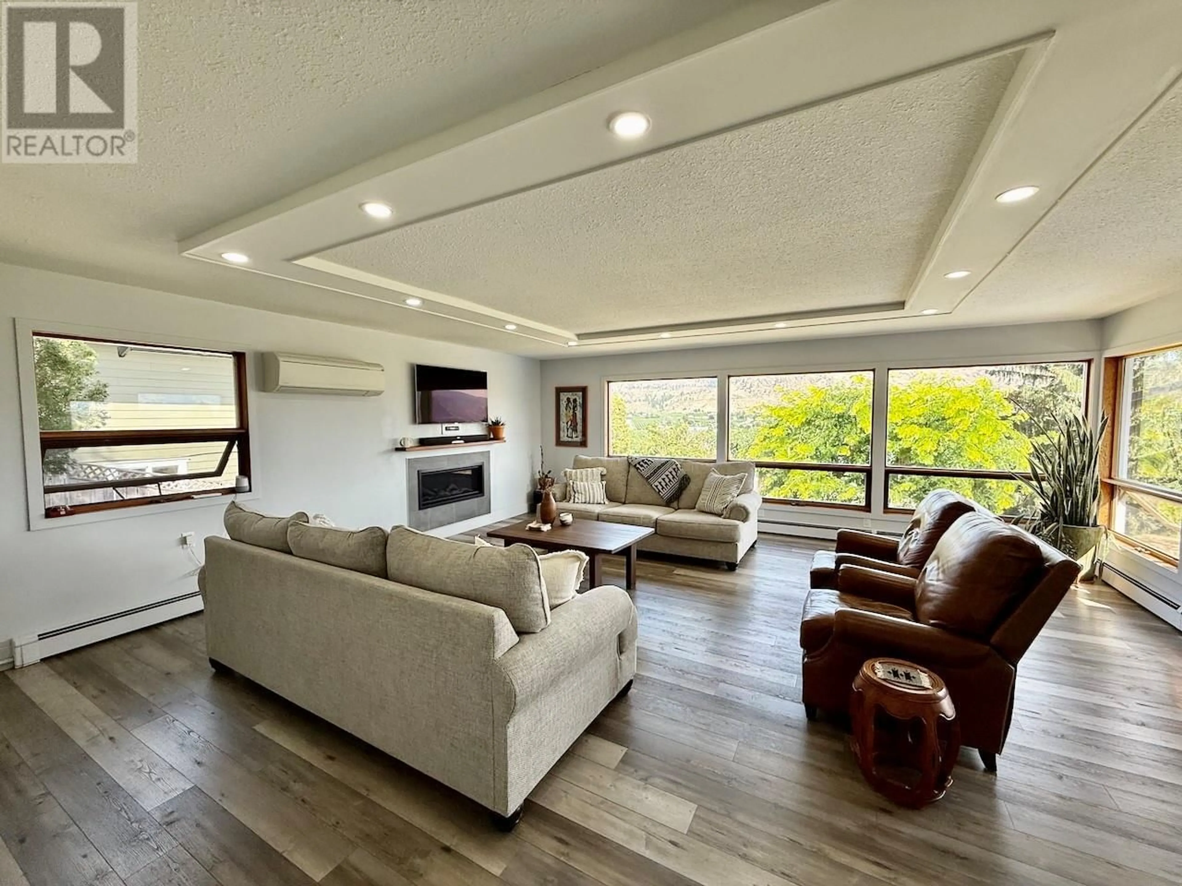Living room with furniture, wood/laminate floor for 5622 YARROW STREET, Oliver British Columbia V0H1T9