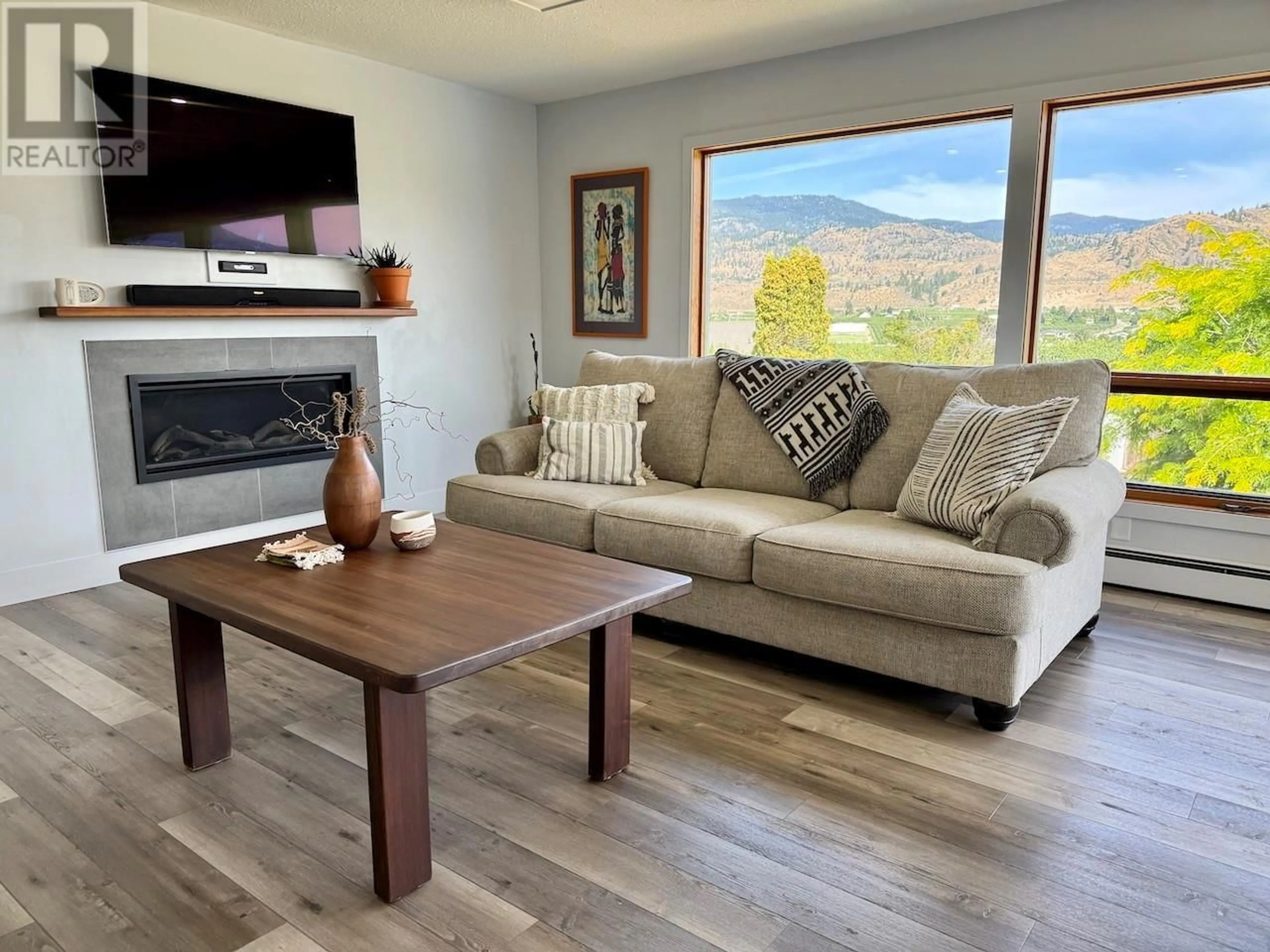 Living room with furniture, wood/laminate floor for 5622 YARROW STREET, Oliver British Columbia V0H1T9