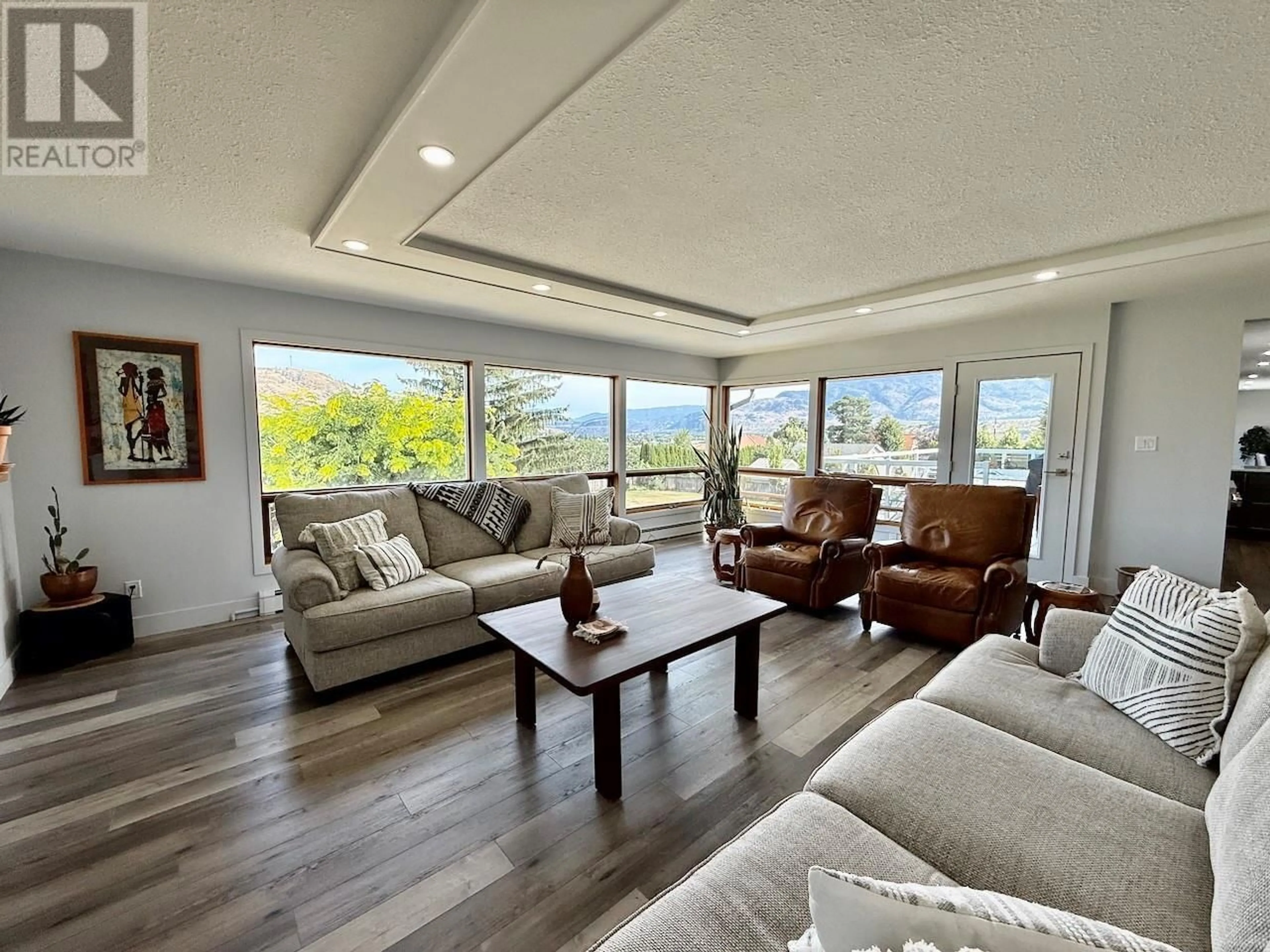 Living room with furniture, wood/laminate floor for 5622 YARROW STREET, Oliver British Columbia V0H1T9