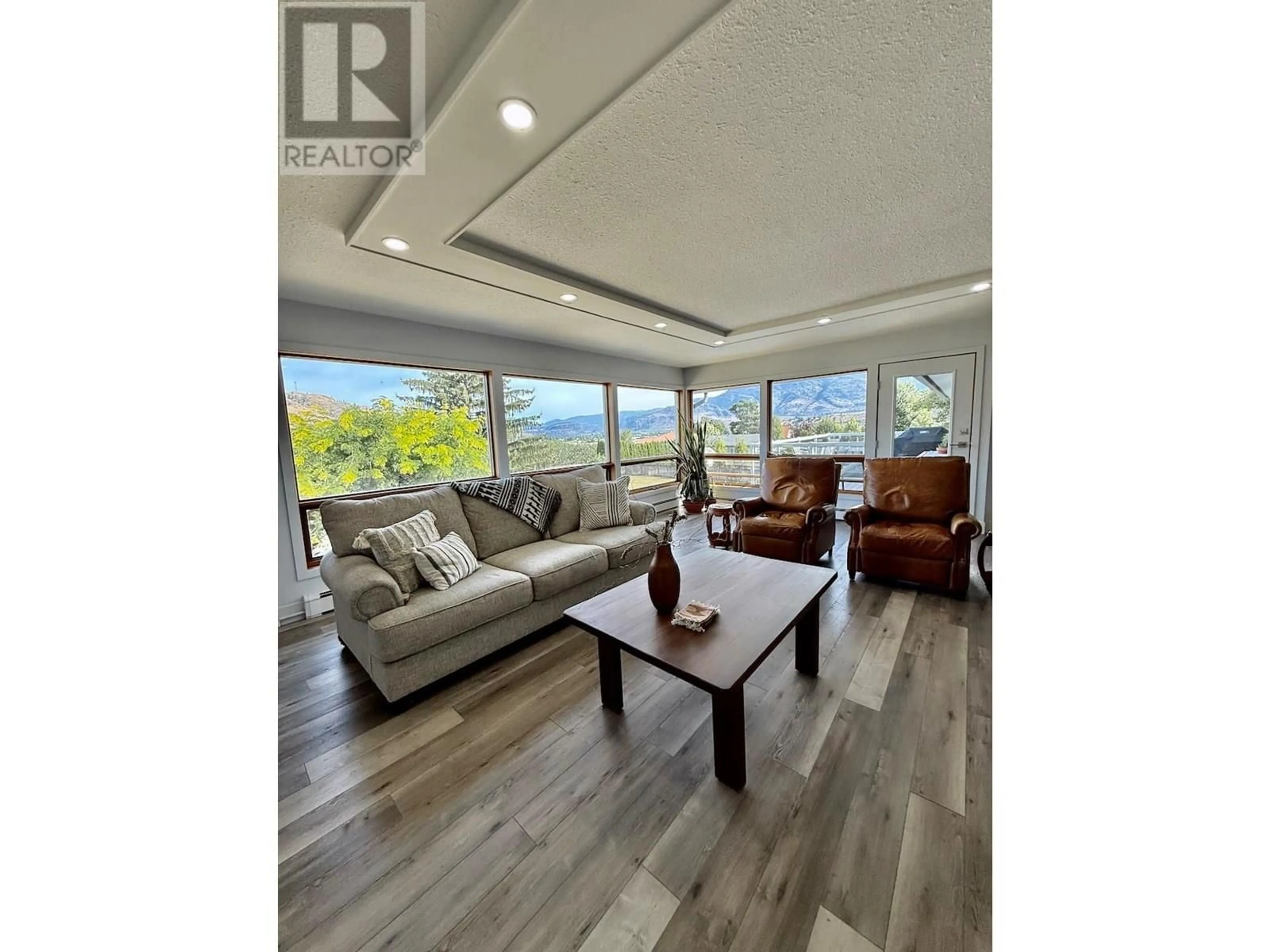 Living room with furniture, wood/laminate floor for 5622 YARROW STREET, Oliver British Columbia V0H1T9