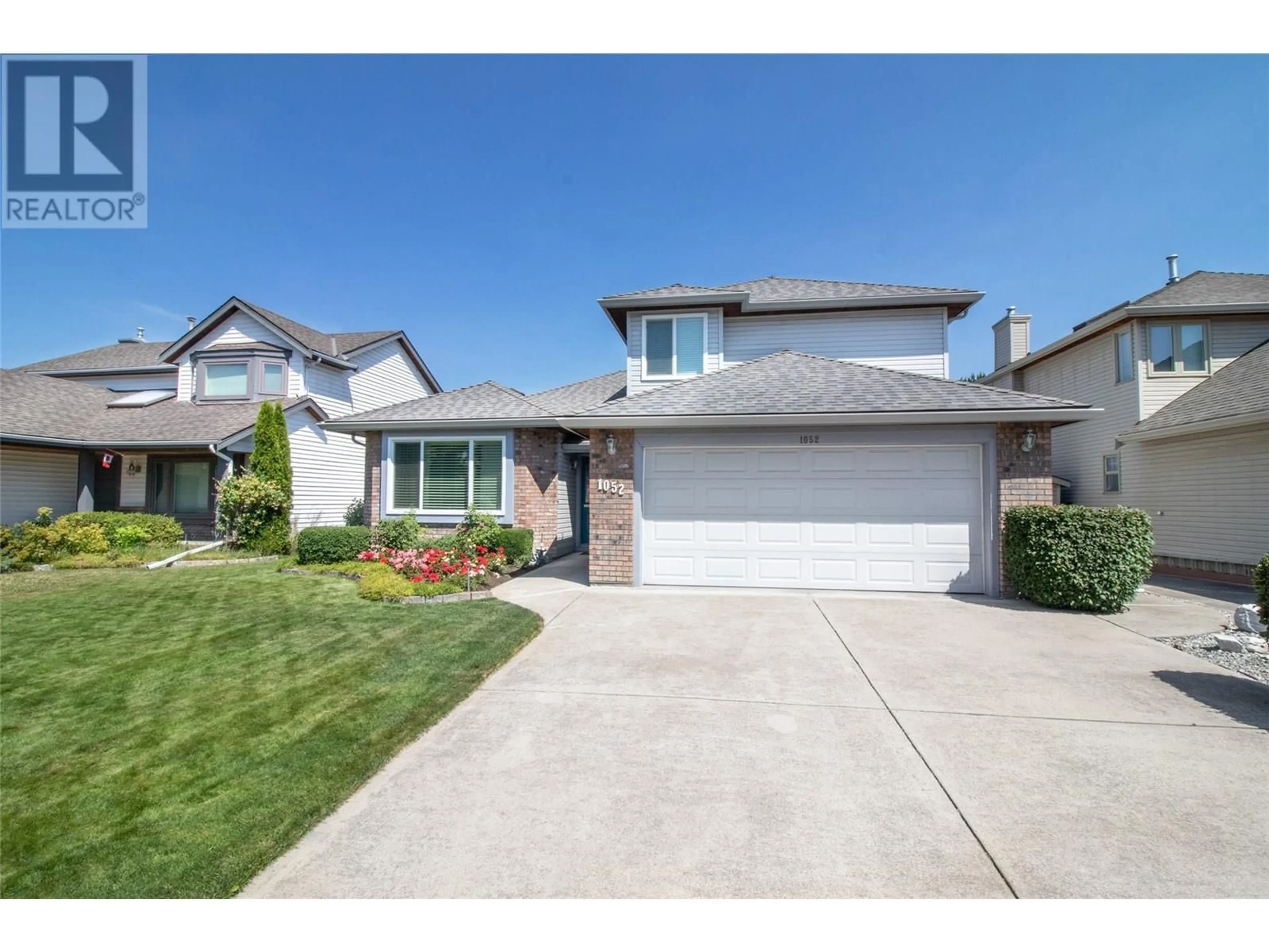 Home with vinyl exterior material, street for 1052 WINTERGREEN DRIVE, Kelowna British Columbia V1W3V7