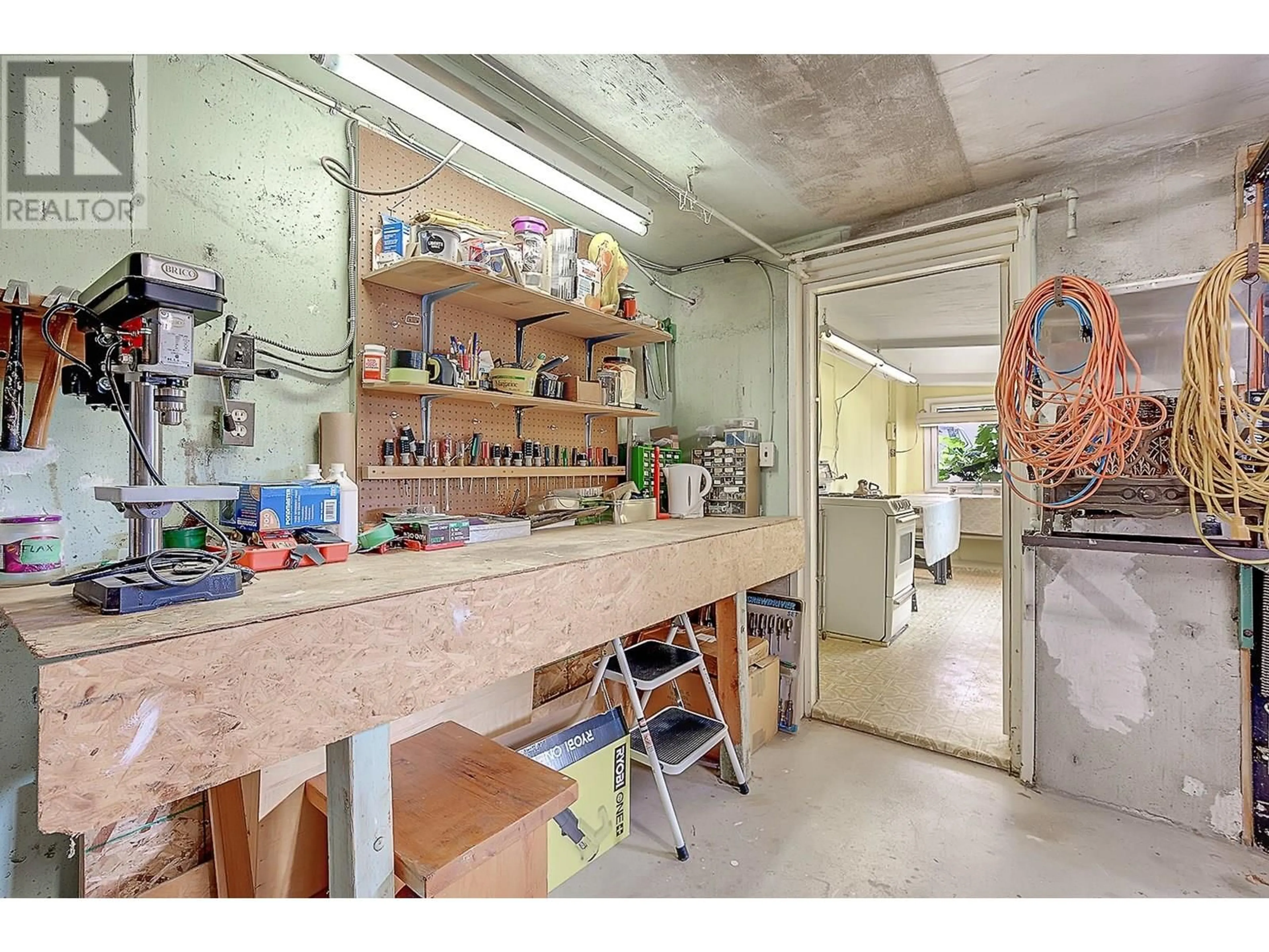 Kitchen with laundary machines, cement floor for 853 FRANWILL ROAD, West Kelowna British Columbia V1Z1P7