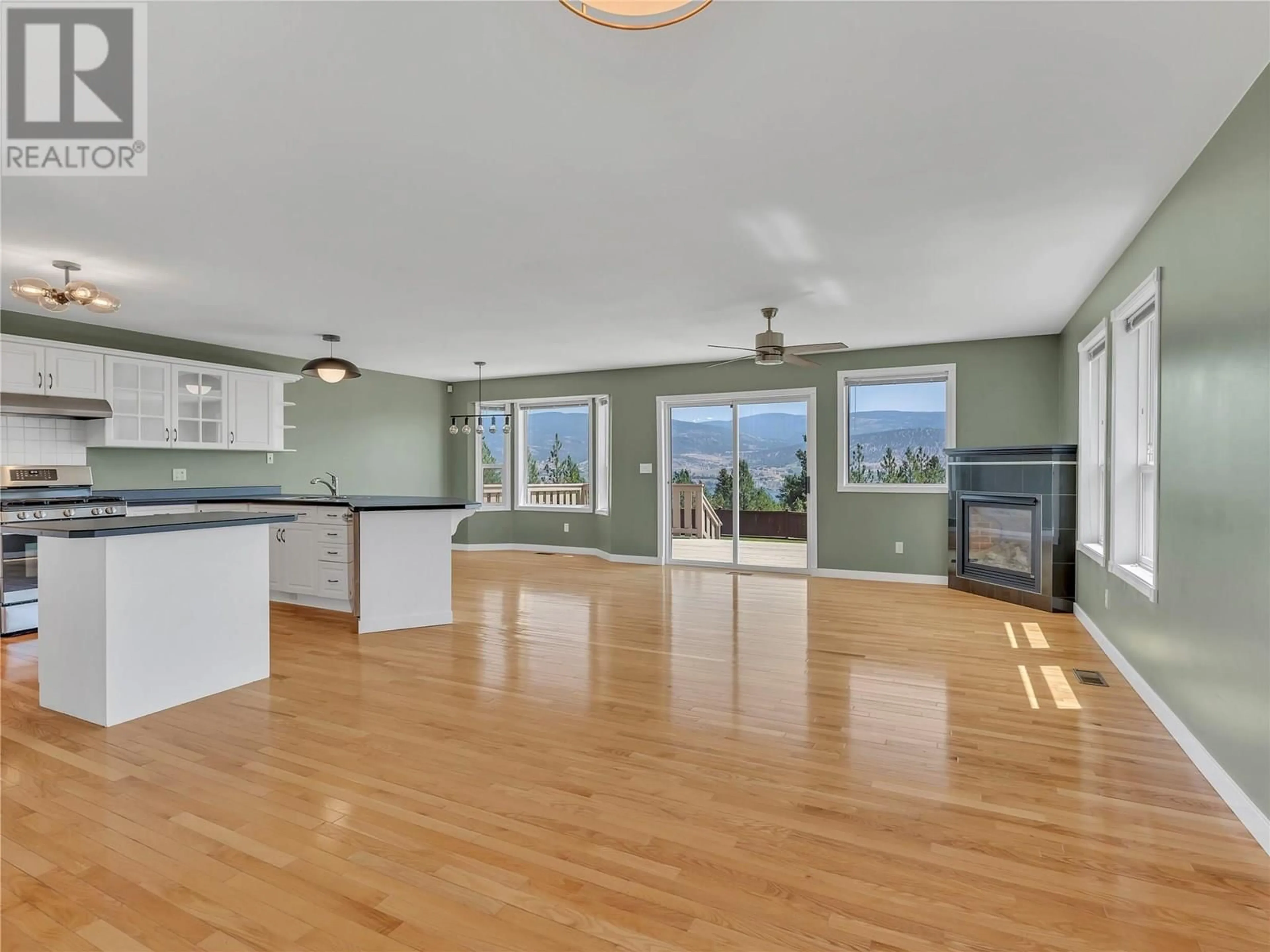 Open concept kitchen, wood/laminate floor for 1893 SANDSTONE DRIVE, Penticton British Columbia V2A8Y6