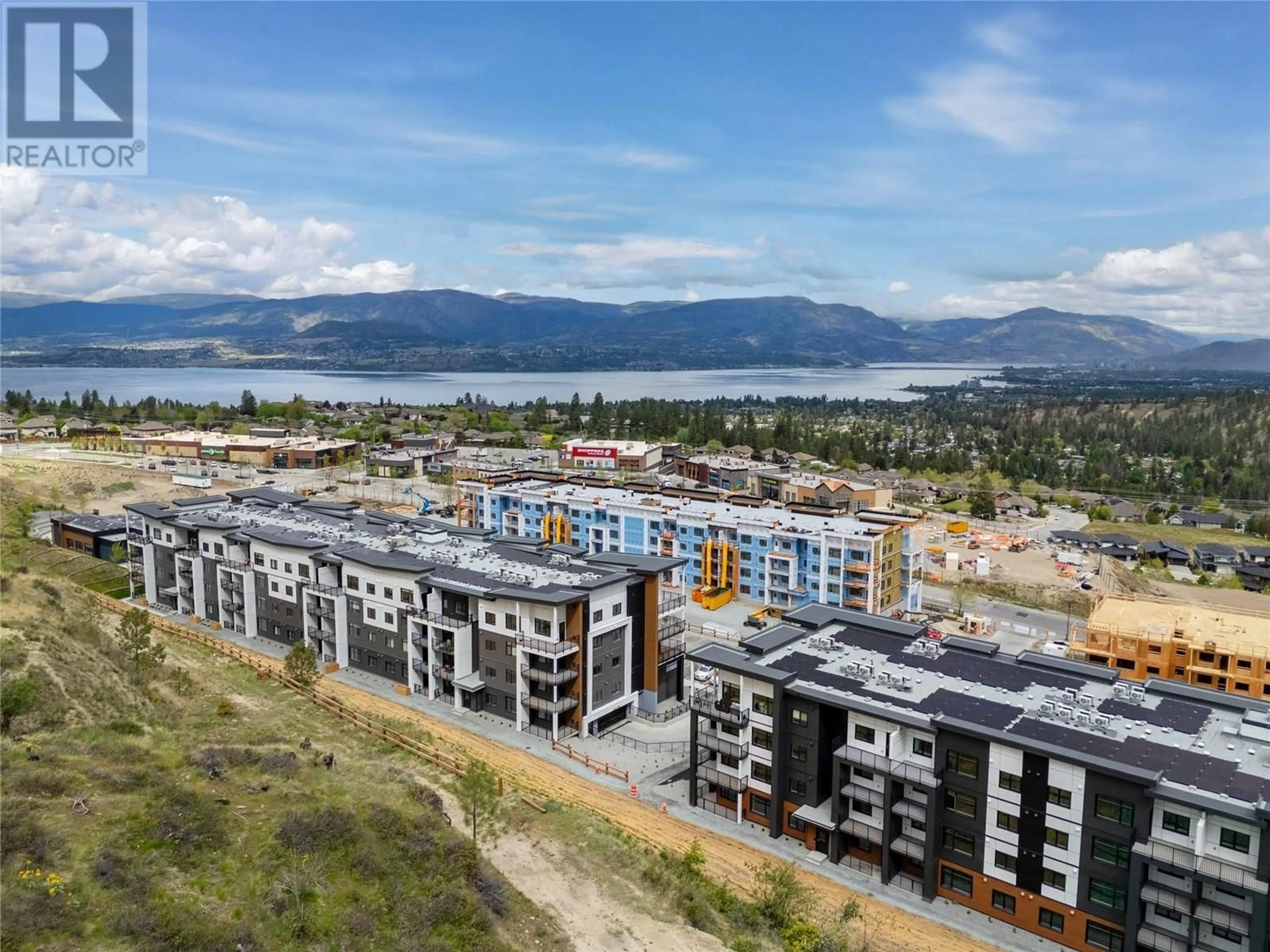 A pic from outside/outdoor area/front of a property/back of a property/a pic from drone, mountain view for 412 - 1057 FROST ROAD, Kelowna British Columbia V1W0G7