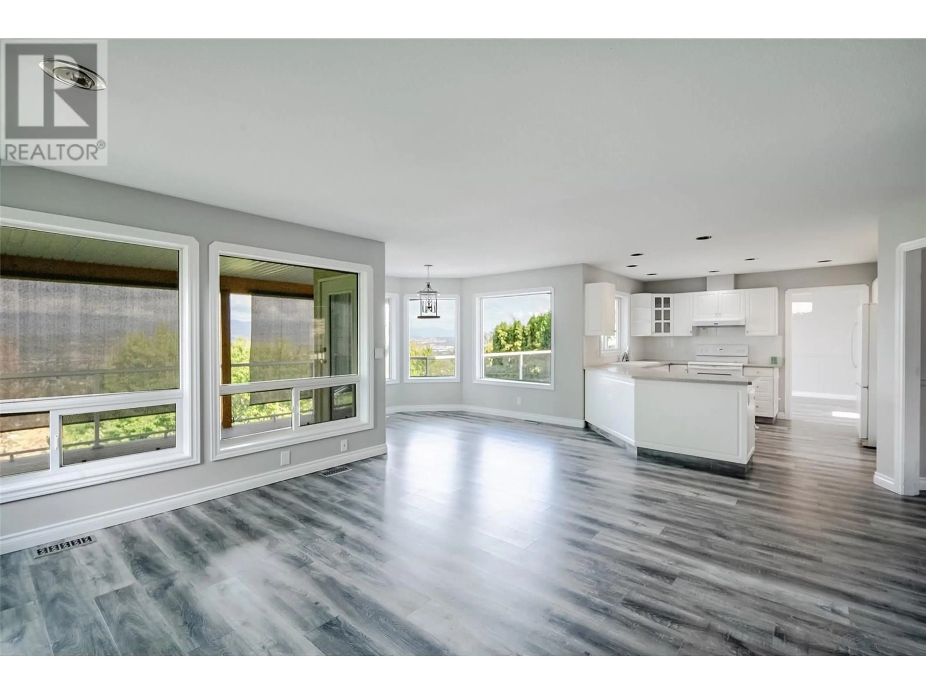 Open concept kitchen, wood/laminate floor for 1180 RAY ROAD, Kelowna British Columbia V1X6R5