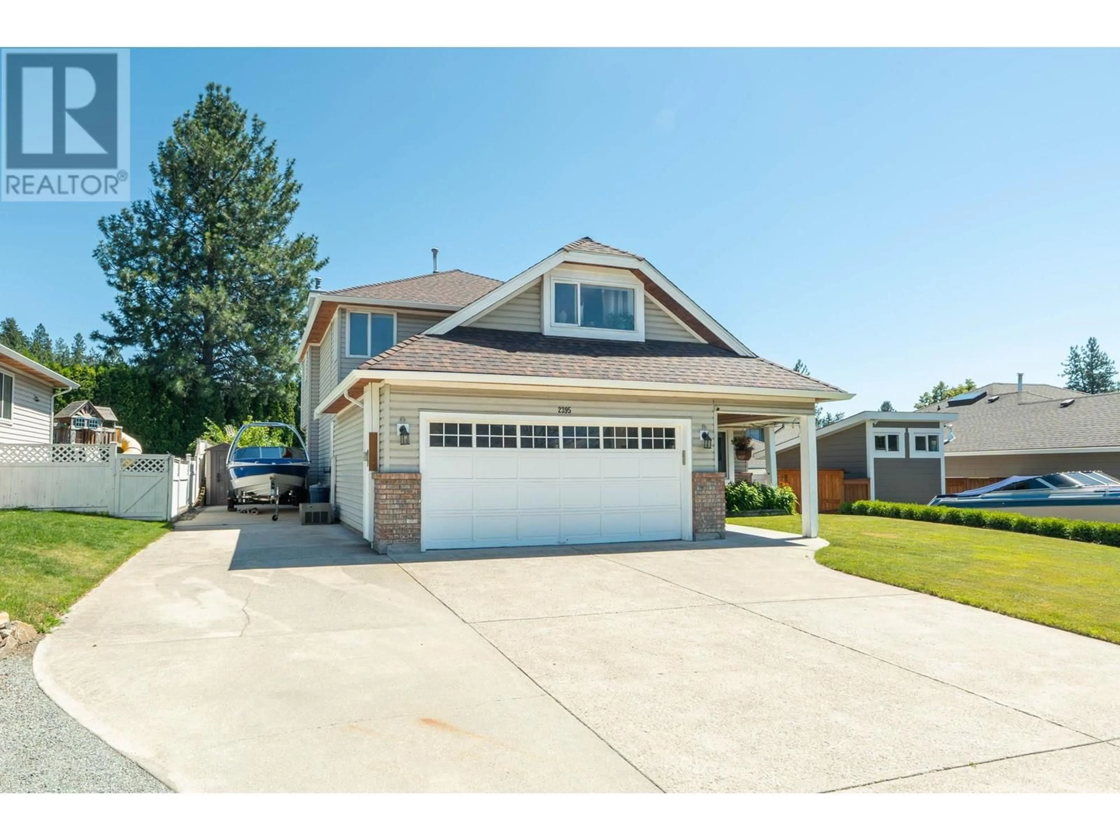 Home with vinyl exterior material, street for 2395 SHANNON RIDGE DRIVE, West Kelowna British Columbia V4T1T1