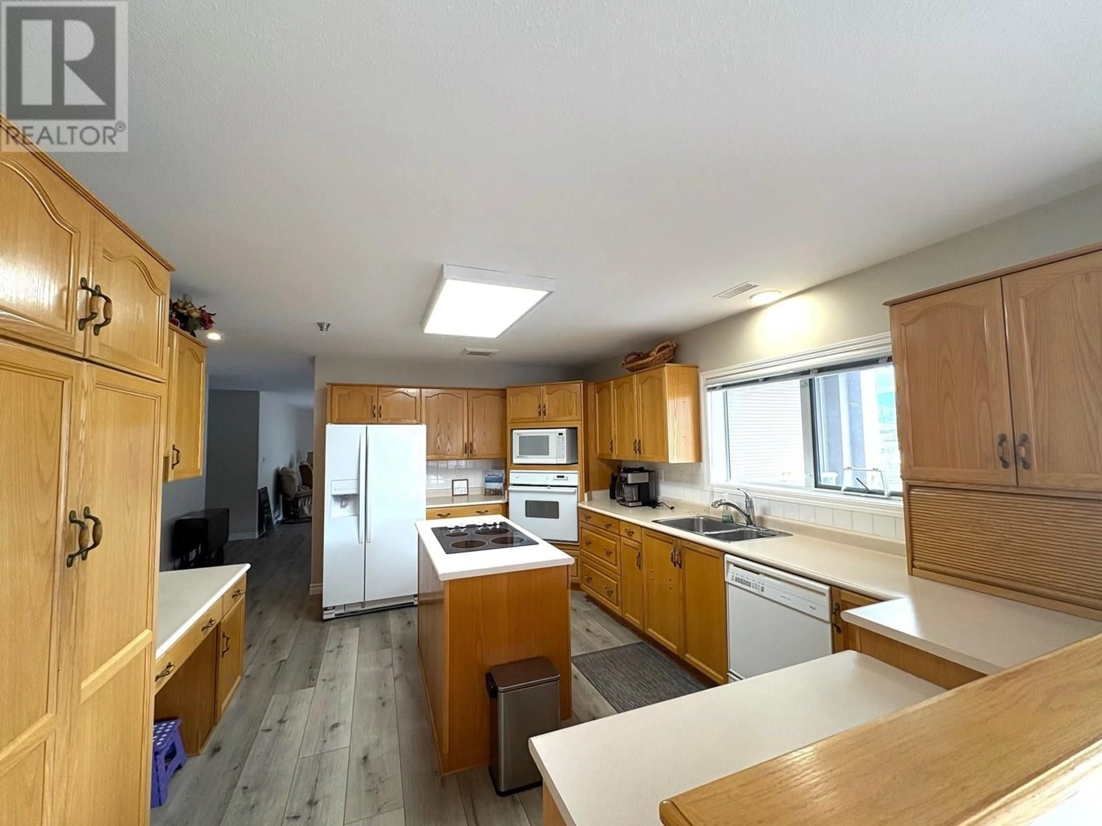Open concept kitchen, wood/laminate floor for 704 - 2245 ATKINSON STREET, Penticton British Columbia V2A8R7
