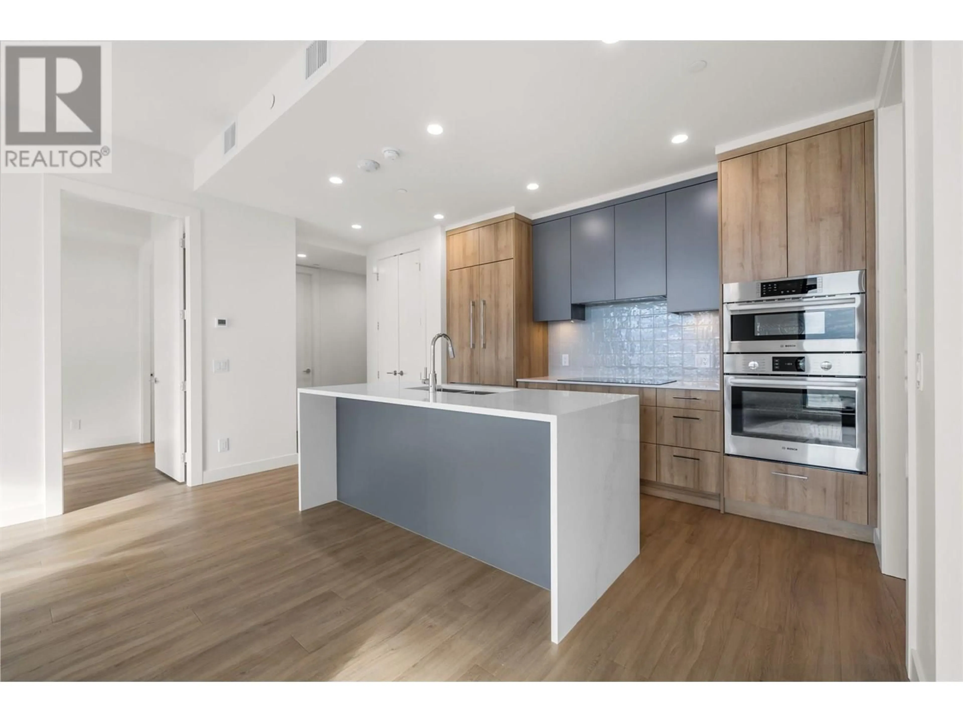 Open concept kitchen, wood/laminate floor for PH3 - 3699 CAPOZZI ROAD, Kelowna British Columbia V1W0G3