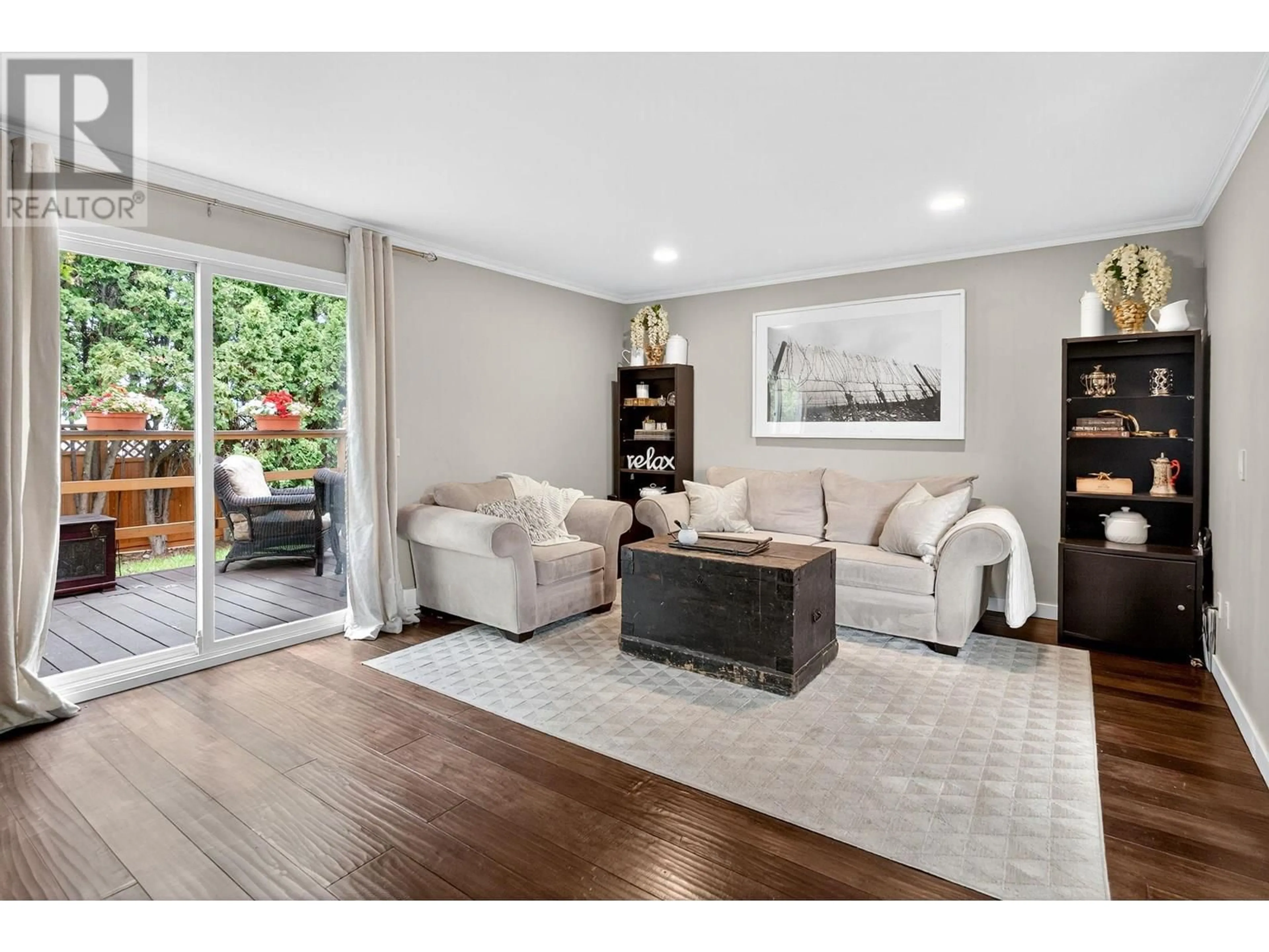 Living room with furniture, wood/laminate floor for 10 - 500 LESTER ROAD, Kelowna British Columbia V1X6E2