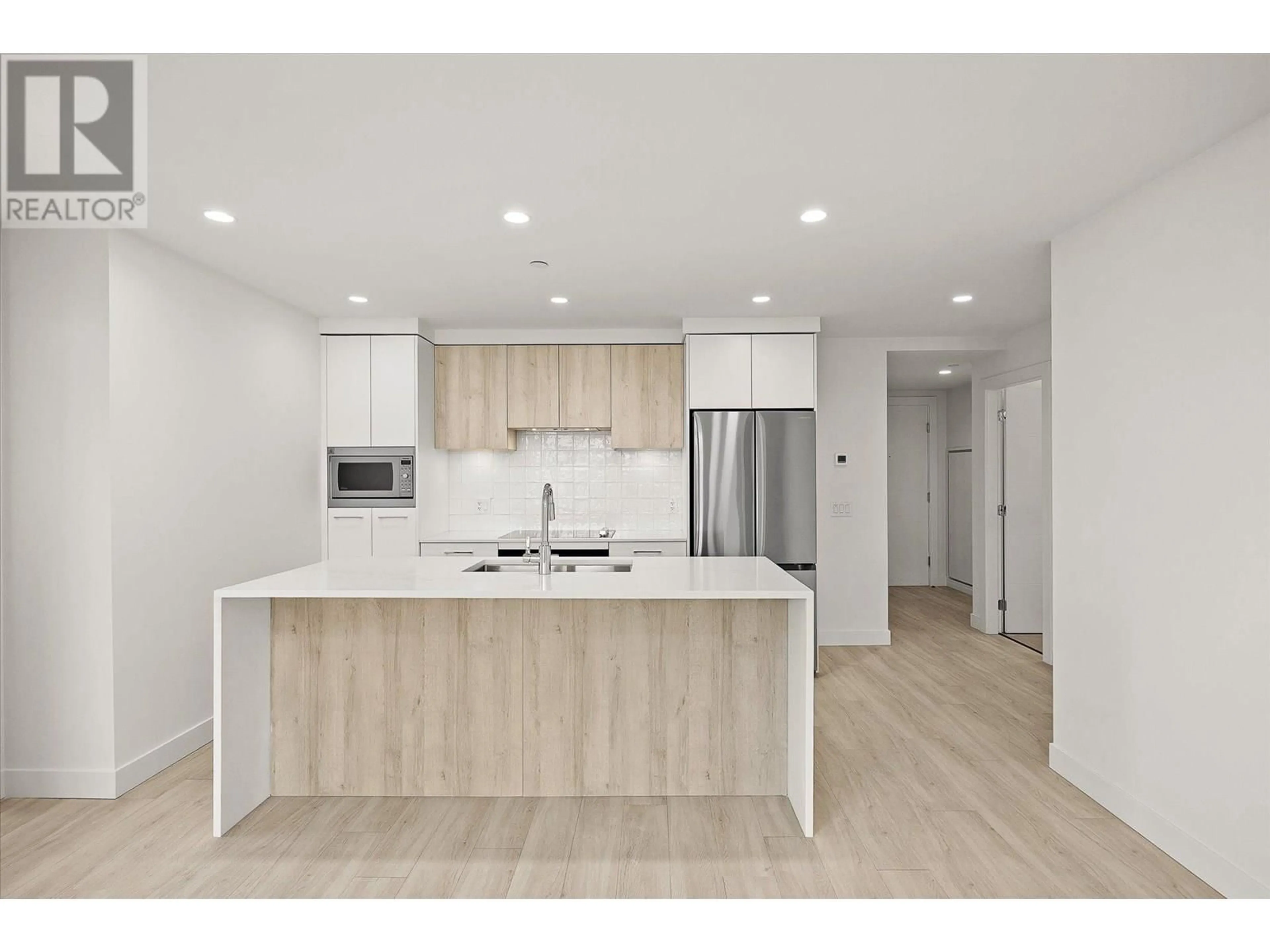 Open concept kitchen, wood/laminate floor for 508 - 3699 CAPOZZI ROAD, Kelowna British Columbia V1W0G3