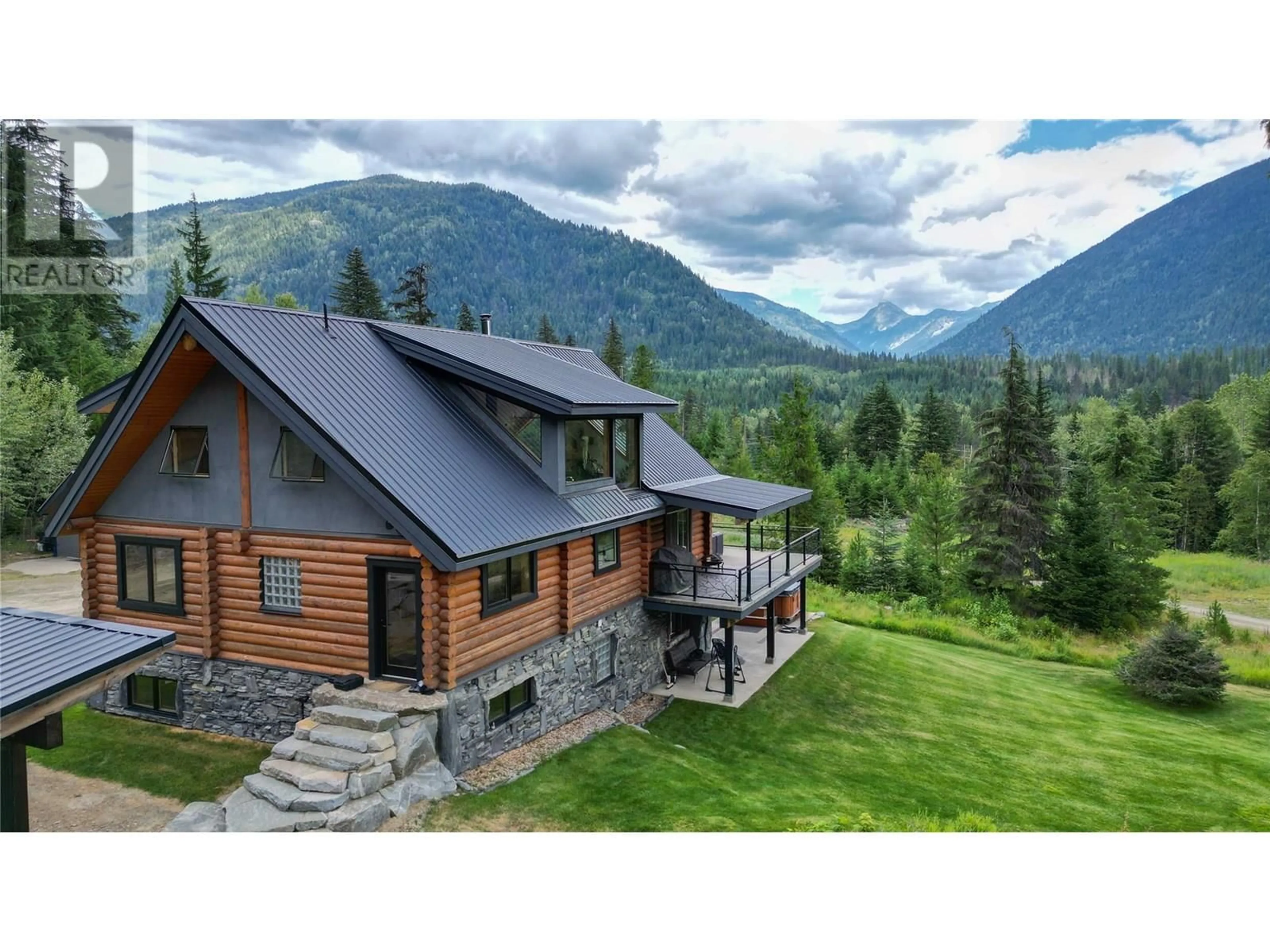 A pic from outside/outdoor area/front of a property/back of a property/a pic from drone, mountain view for 6580 6 HIGHWAY, Ymir British Columbia V0G2K0