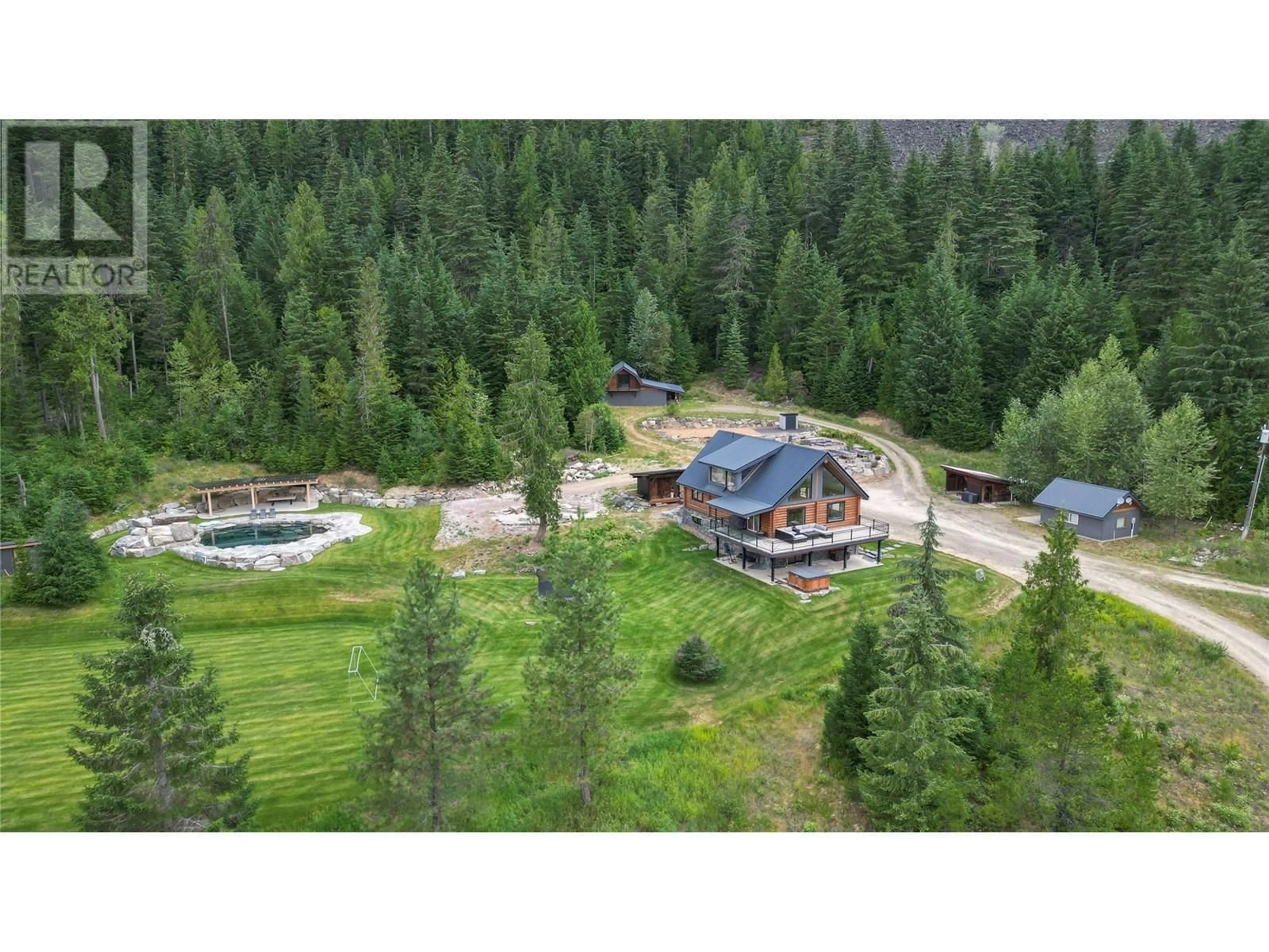 A pic from outside/outdoor area/front of a property/back of a property/a pic from drone, forest/trees view for 6580 6 HIGHWAY, Ymir British Columbia V0G2K0