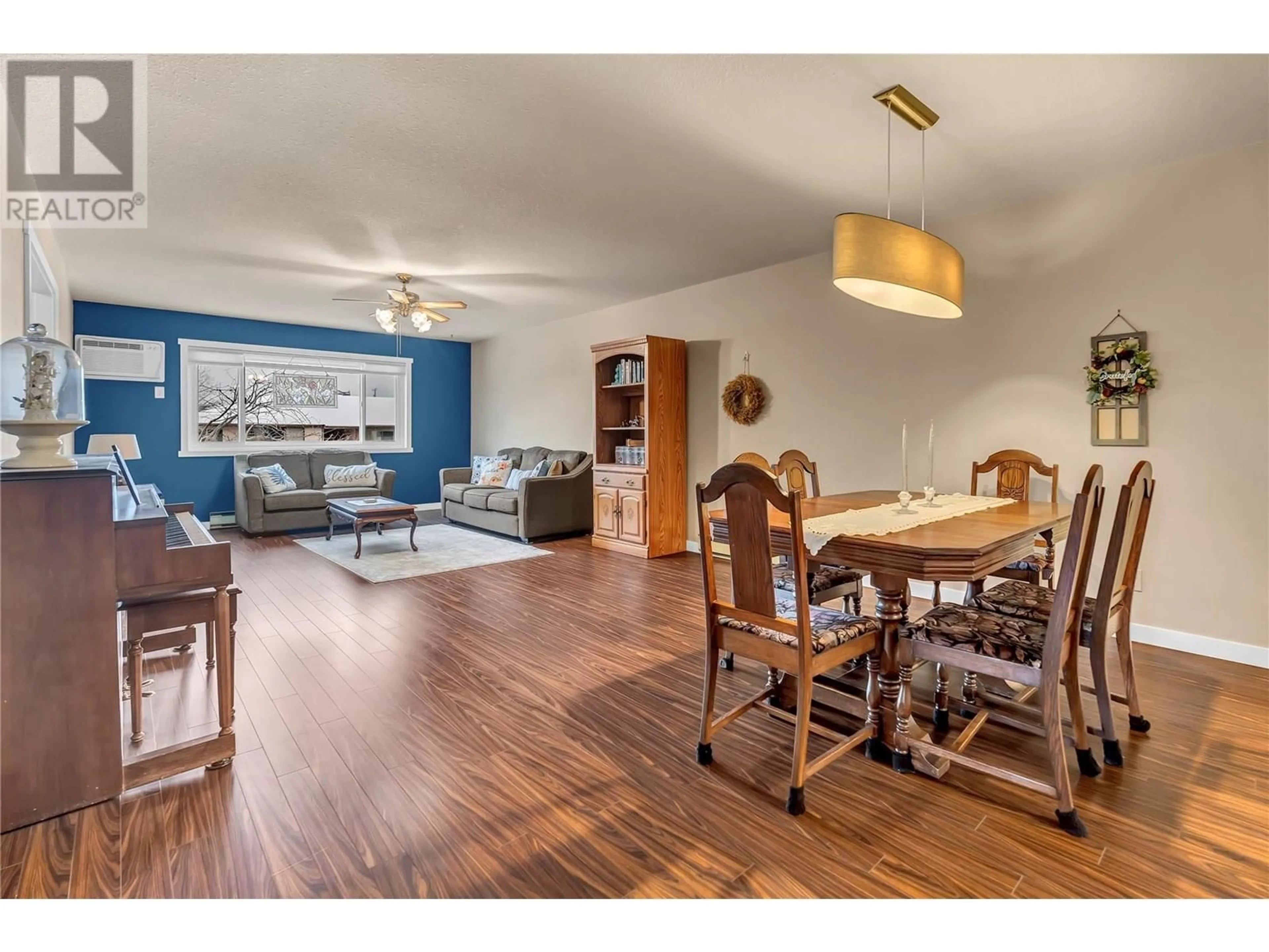 Living room with furniture, wood/laminate floor for 207 - 1820 ATKINSON STREET, Penticton British Columbia V2A7M6