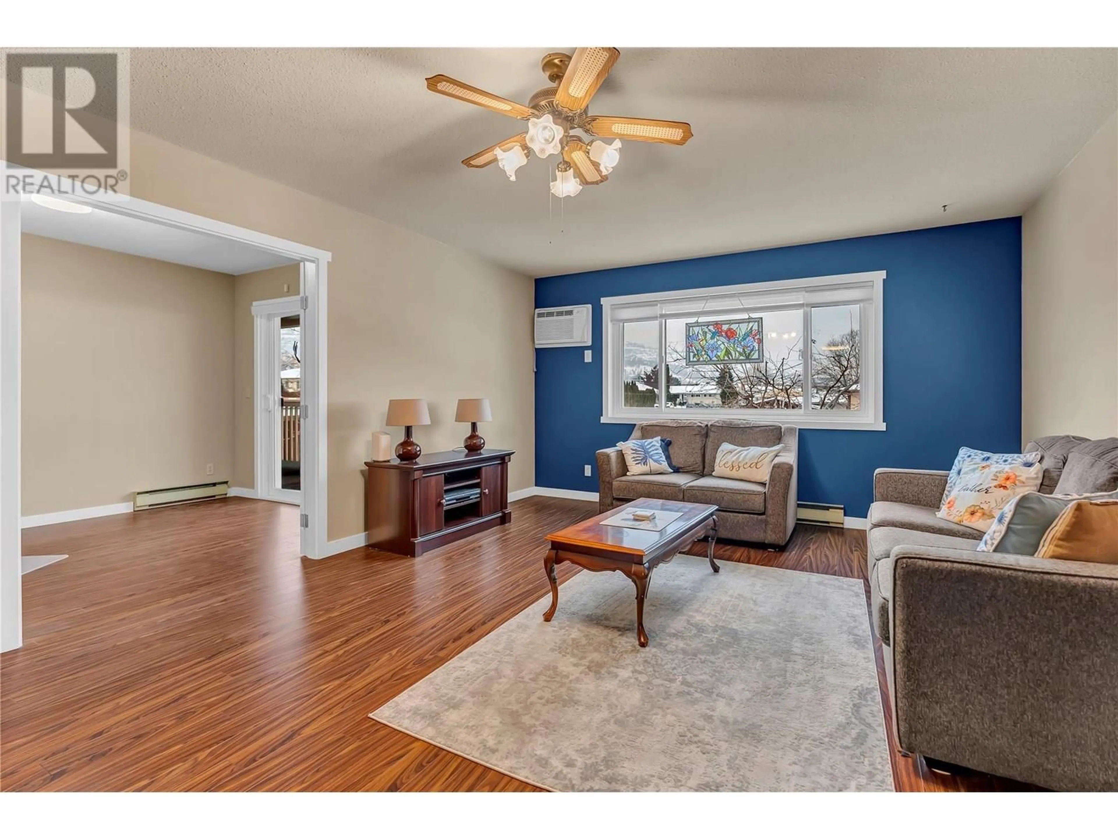 Living room with furniture, wood/laminate floor for 207 - 1820 ATKINSON STREET, Penticton British Columbia V2A7M6