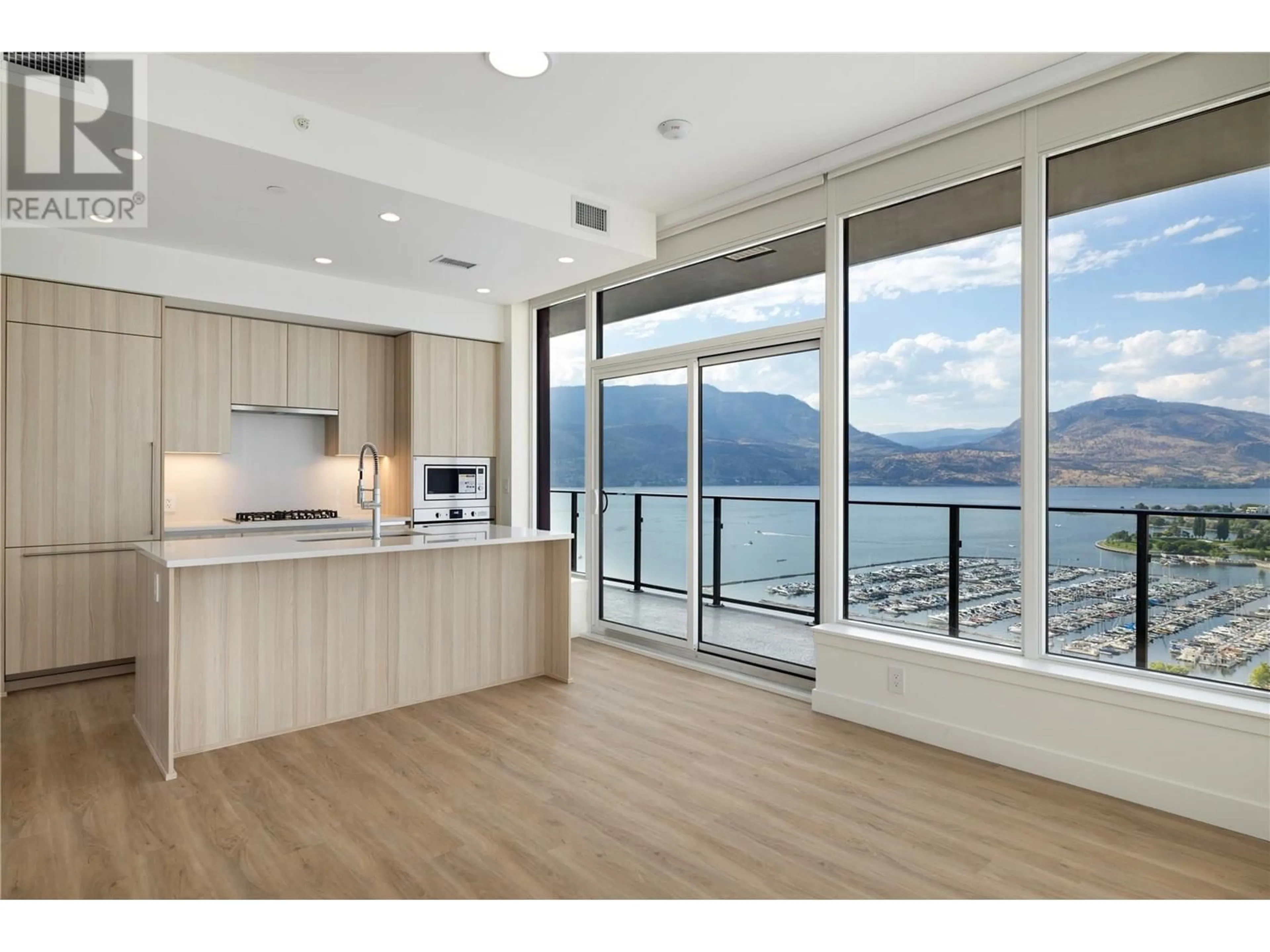 Open concept kitchen, wood/laminate floor for 2102 - 238 LEON AVENUE, Kelowna British Columbia V1Y6H9