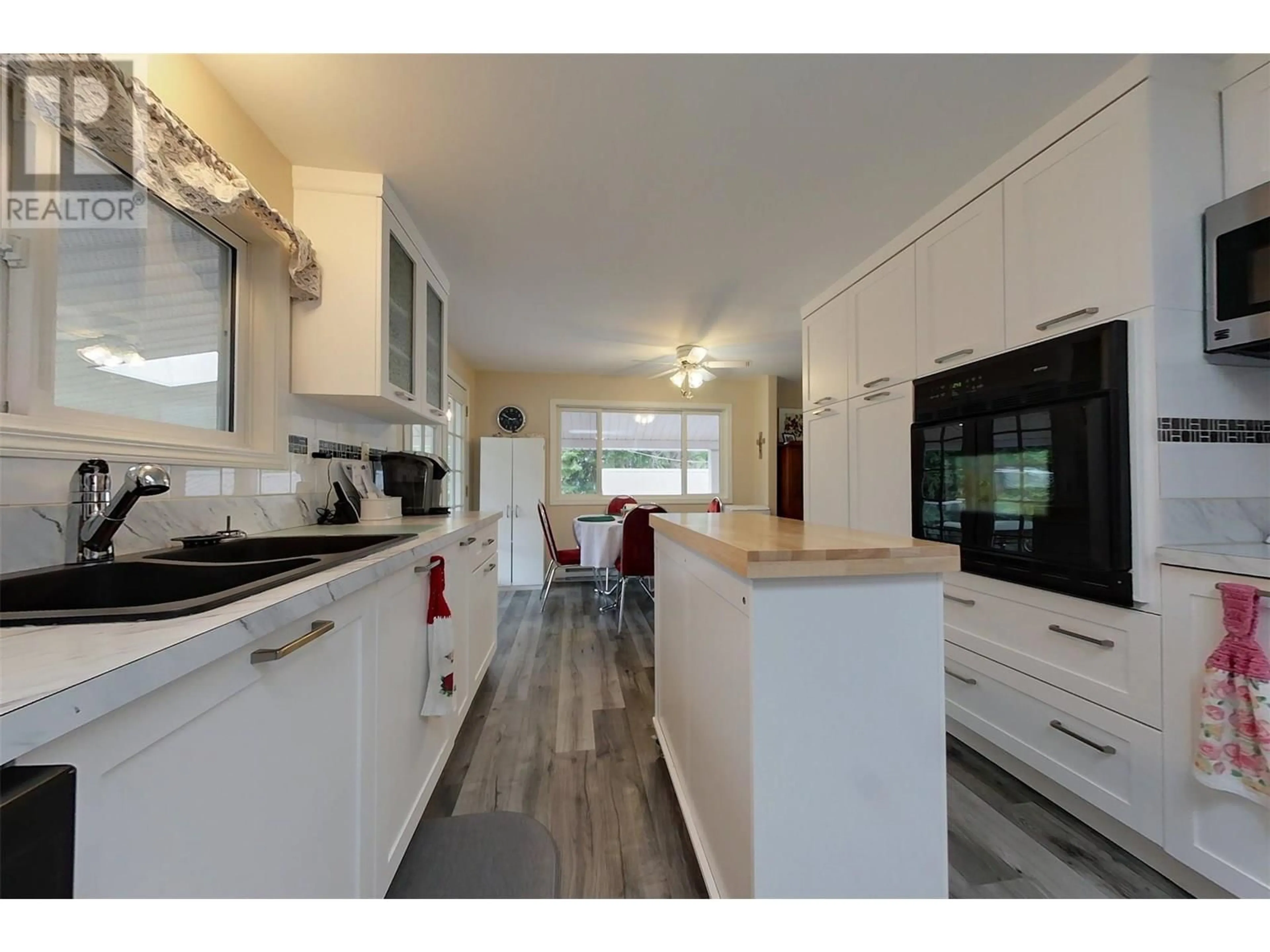 Open concept kitchen, wood/laminate floor for 301 FOWLER STREET, Riondel British Columbia V0B2B0