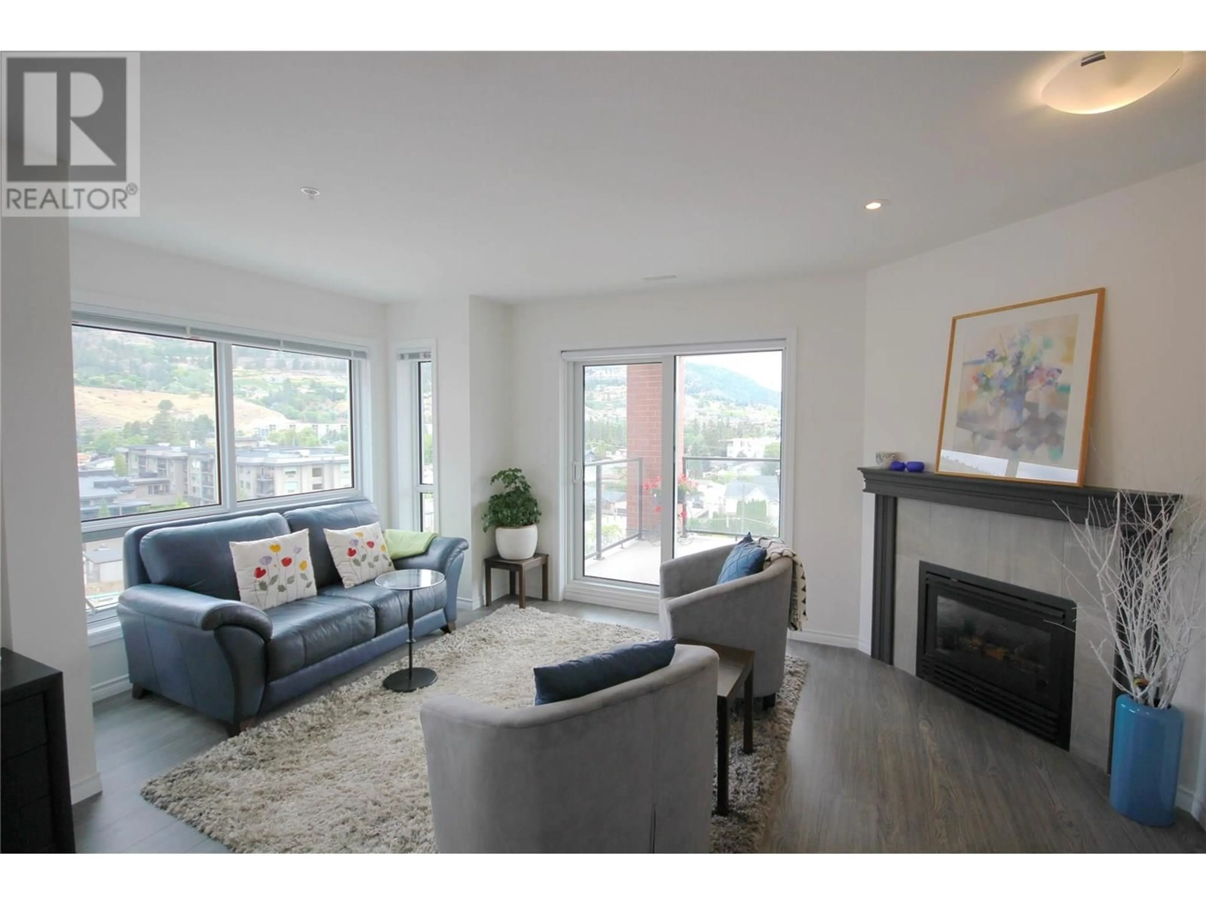 Living room with furniture, wood/laminate floor for 707 - 3388 SKAHA LAKE ROAD, Penticton British Columbia V2A6G4