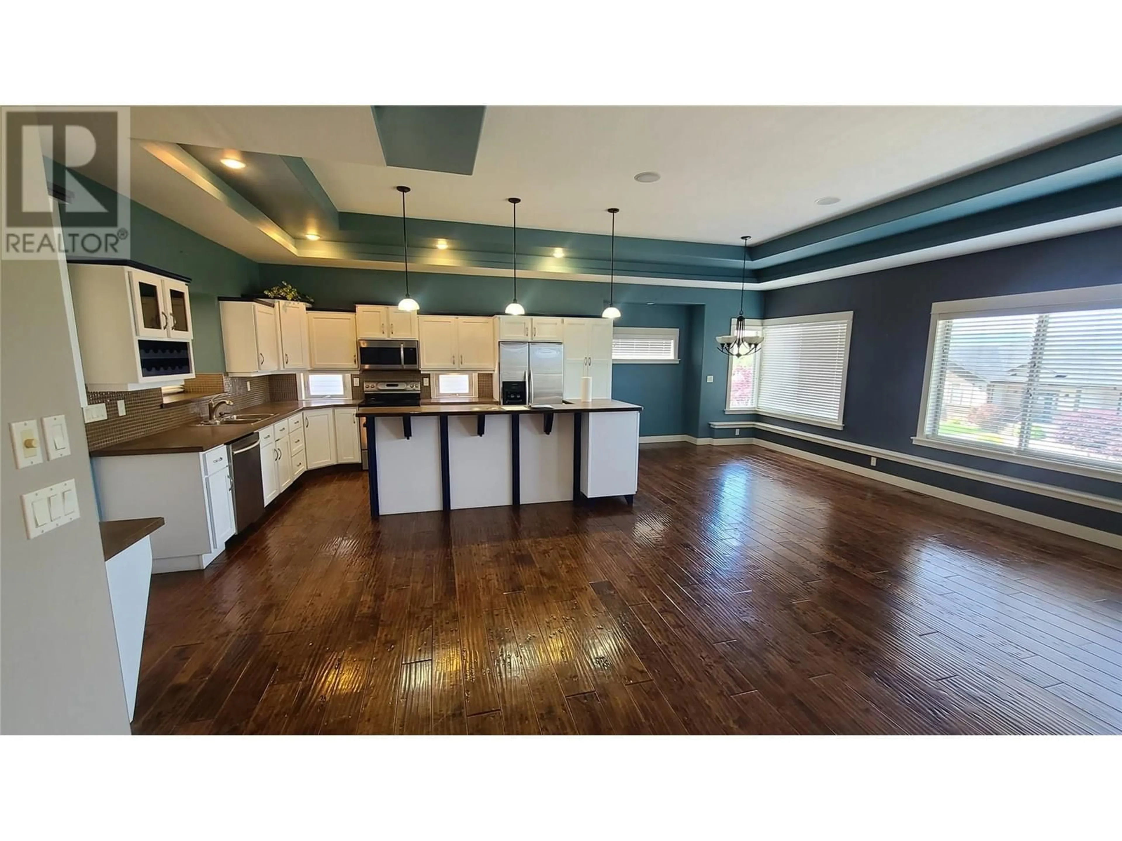 Open concept kitchen, wood/laminate floor for 1047 MT IDA DRIVE, Vernon British Columbia V1B4A7