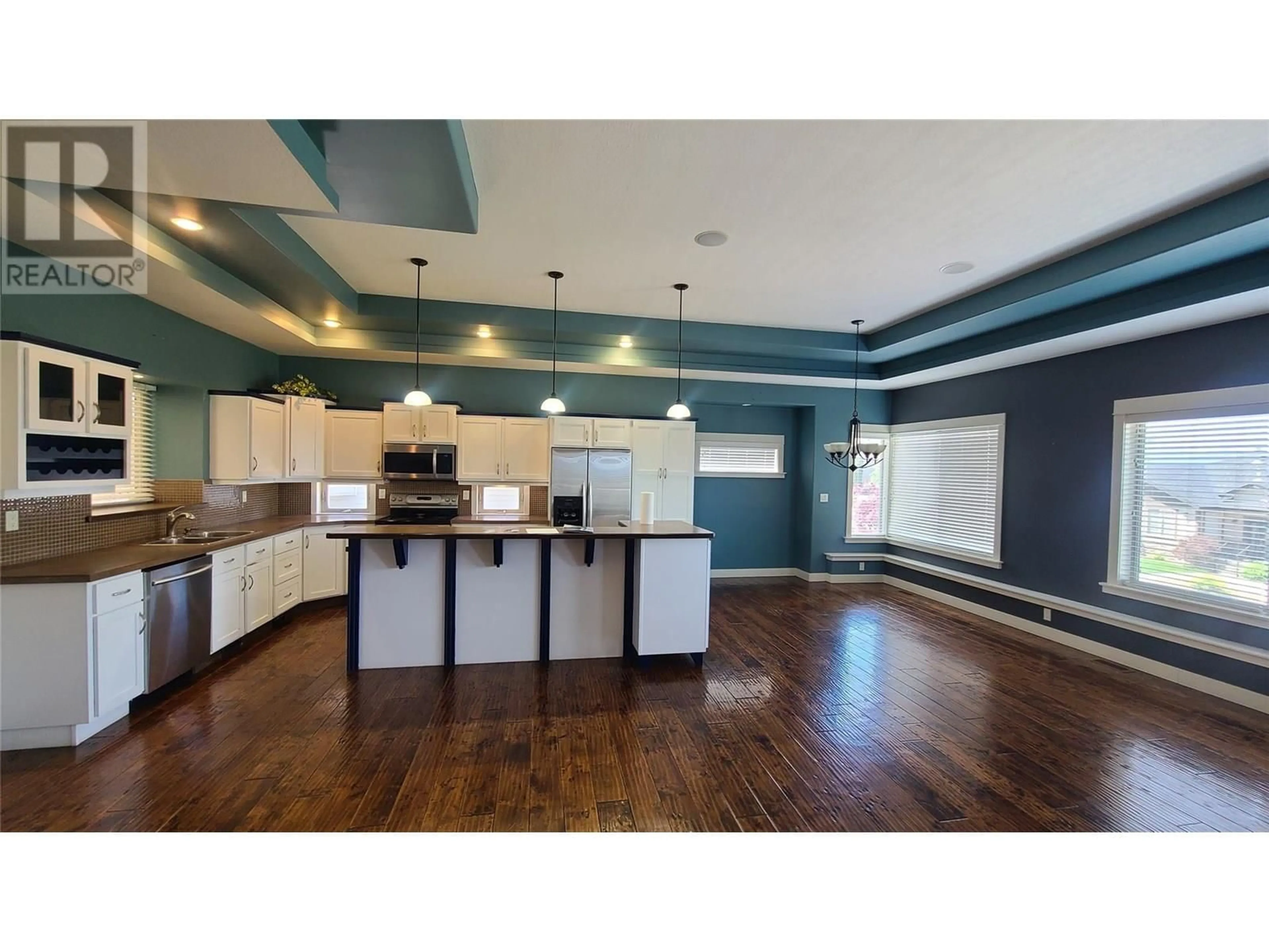 Open concept kitchen, wood/laminate floor for 1047 MT IDA DRIVE, Vernon British Columbia V1B4A7