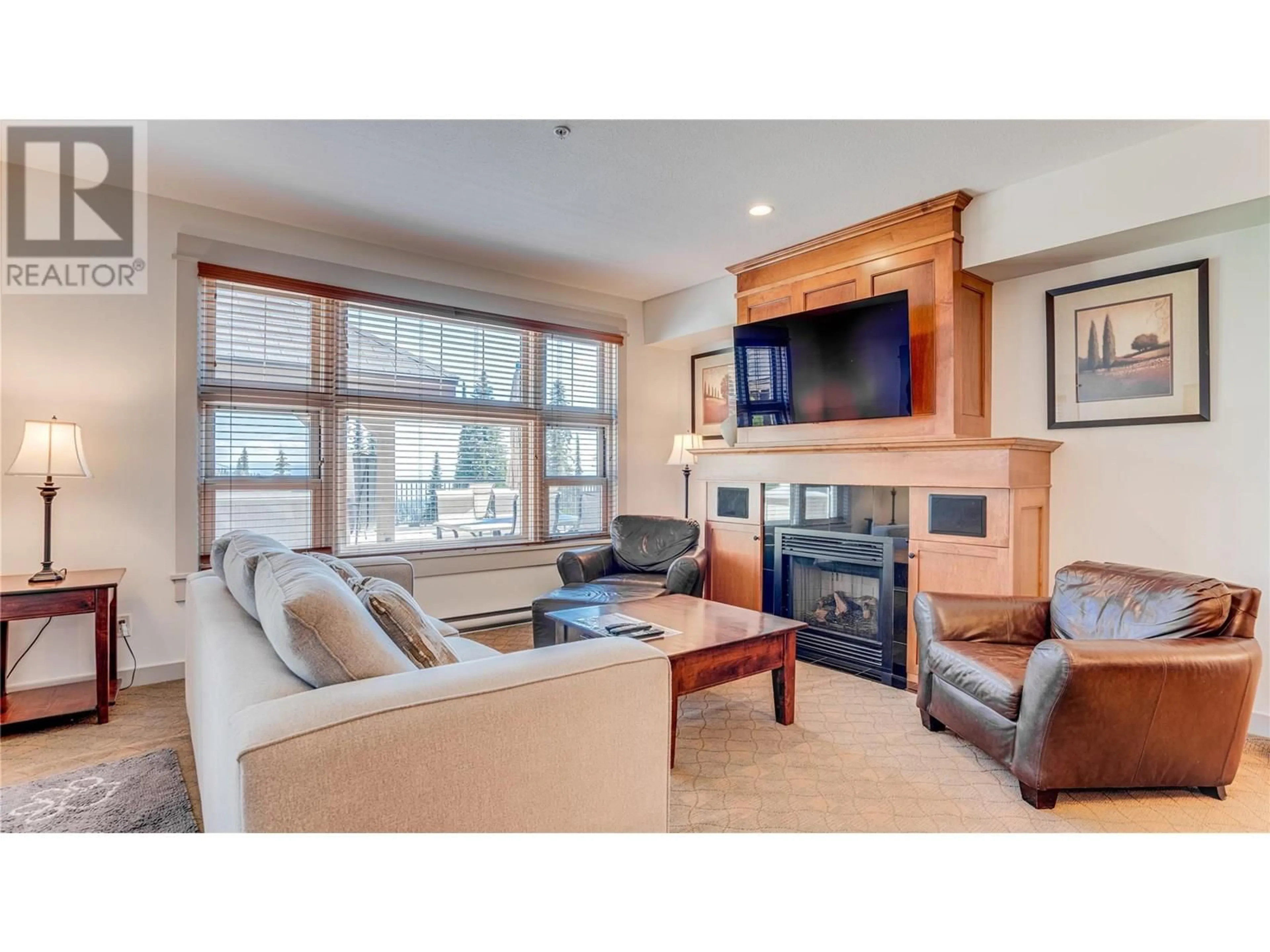 Living room with furniture, wood/laminate floor for 303 - 170 SILVER LODE LANE, Silver Star British Columbia V1B3M1