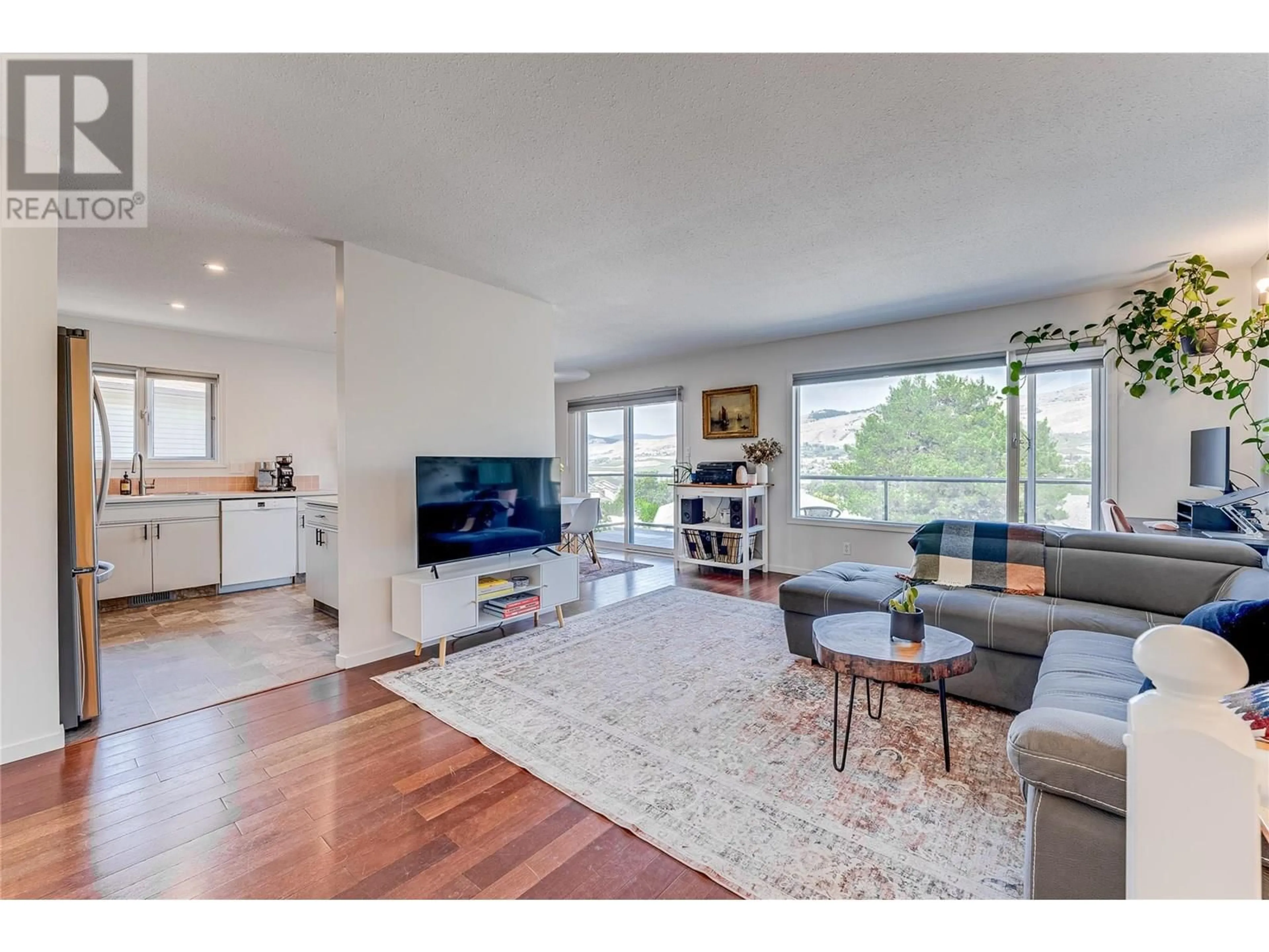 Living room with furniture, wood/laminate floor for 4304 WESTVIEW DRIVE, Vernon British Columbia V1T7M6