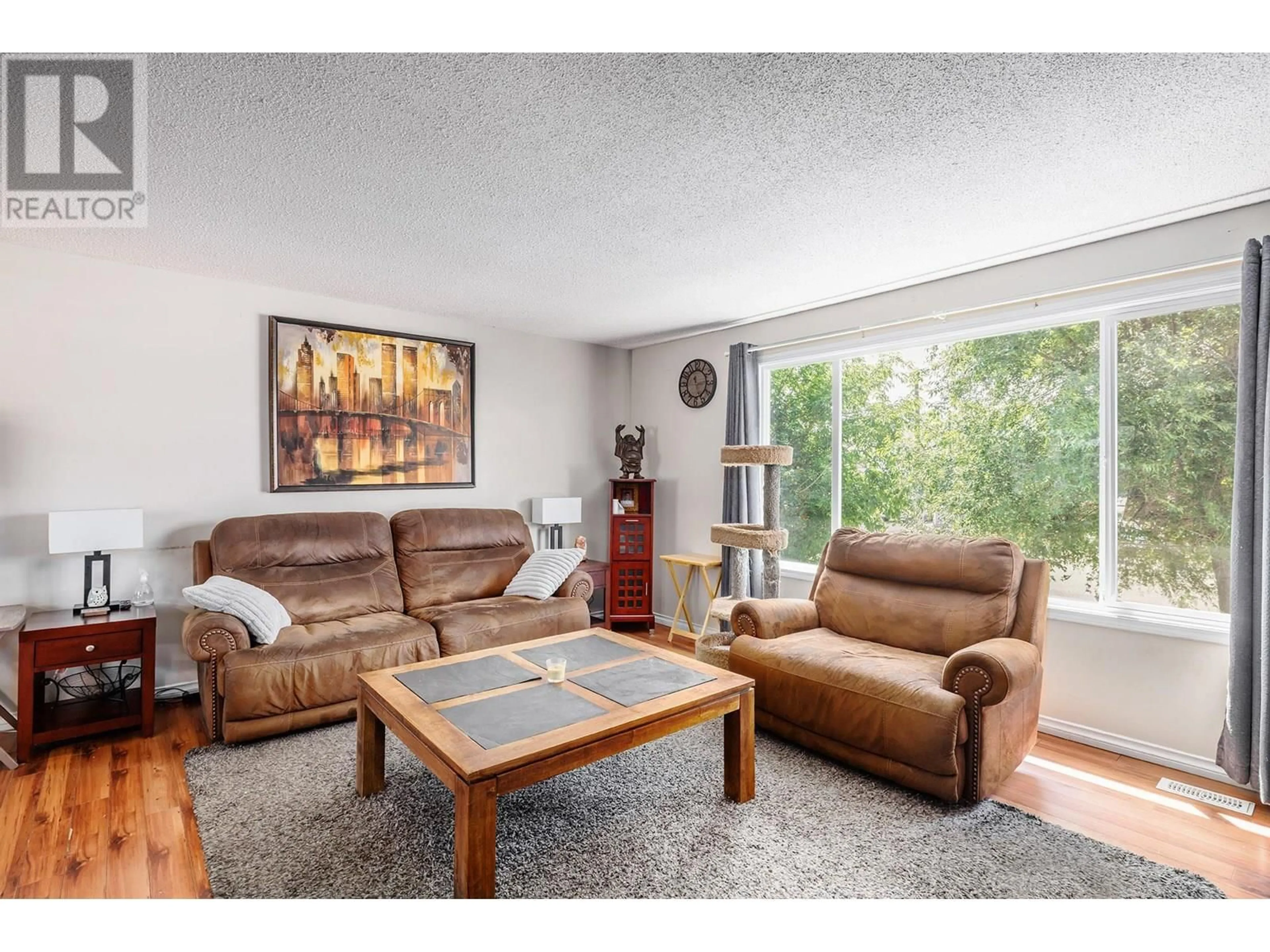 Living room with furniture, wood/laminate floor for 500 KEITHLEY ROAD, Kelowna British Columbia V1X2N7