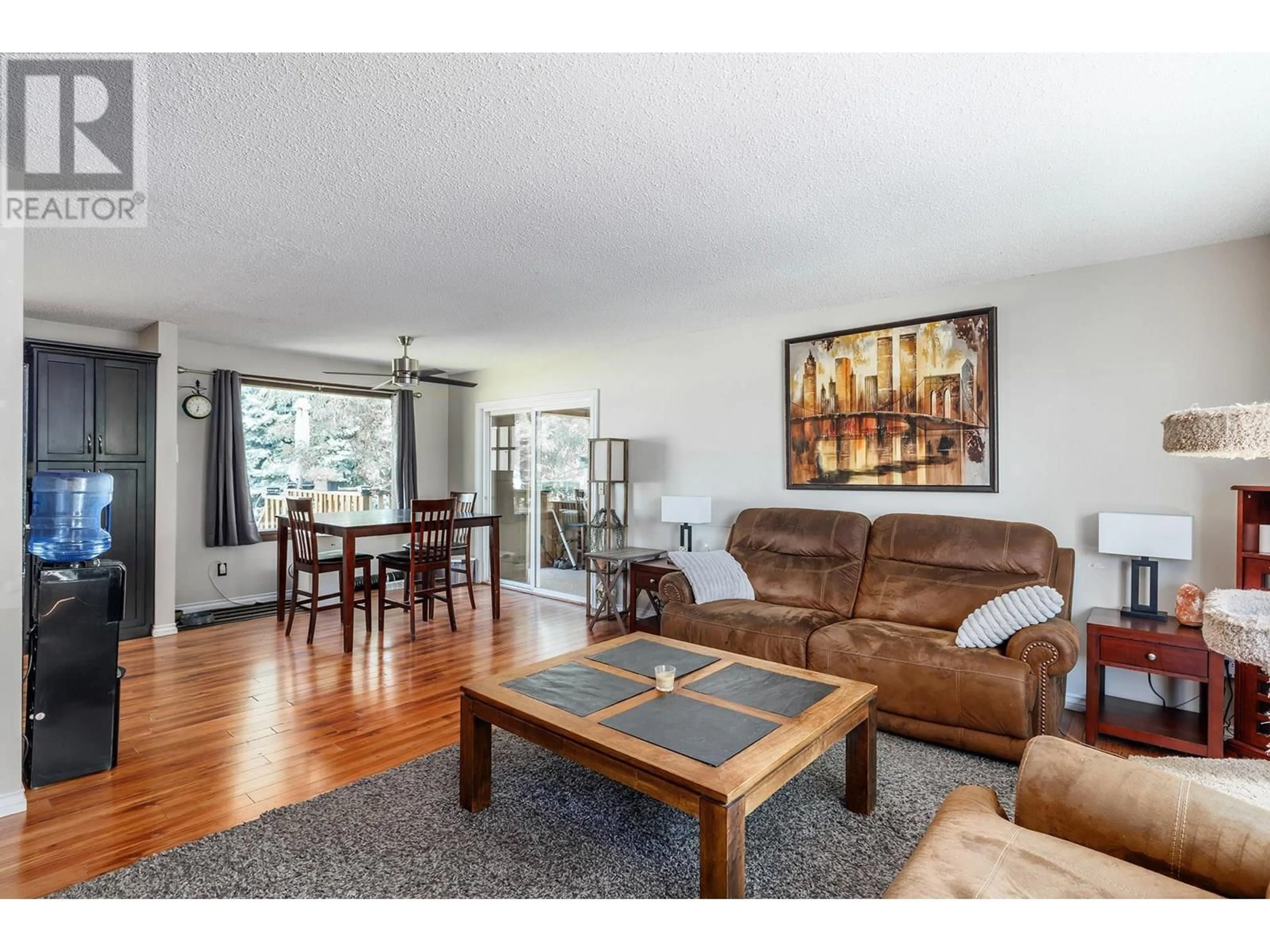 Living room with furniture, wood/laminate floor for 500 KEITHLEY ROAD, Kelowna British Columbia V1X2N7