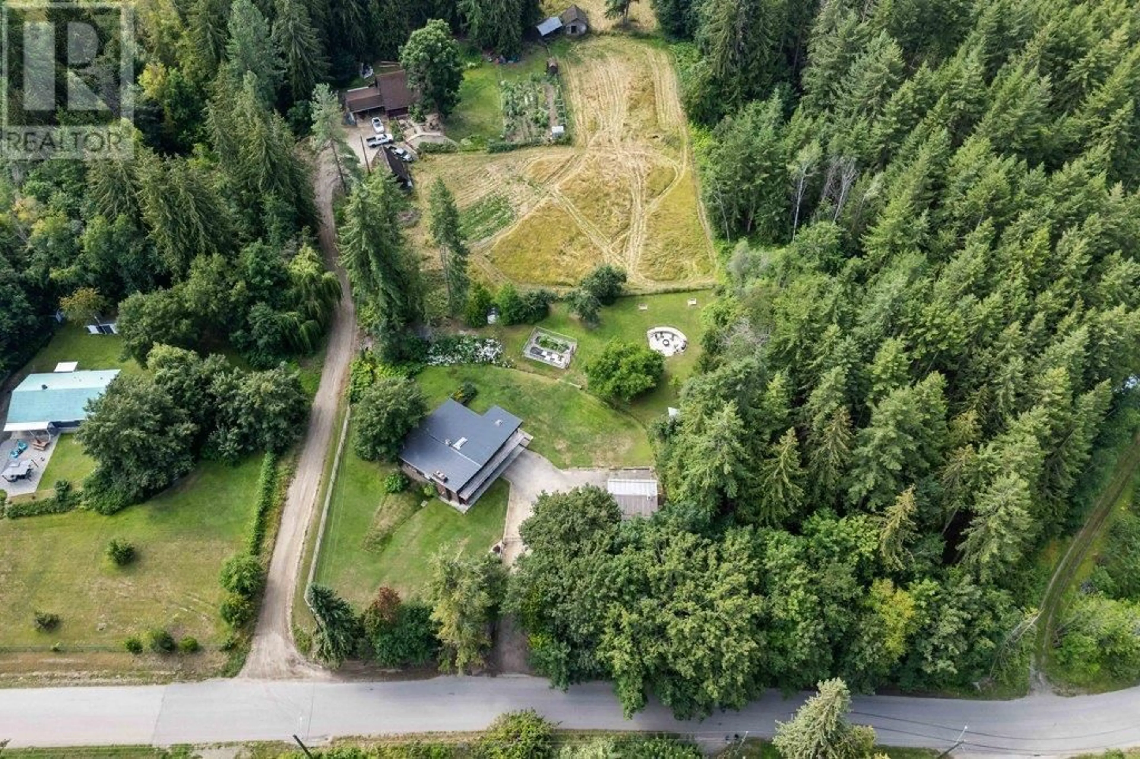 A pic from outside/outdoor area/front of a property/back of a property/a pic from drone, forest/trees view for 5790 70 AVENUE, Salmon Arm British Columbia V0E1K0