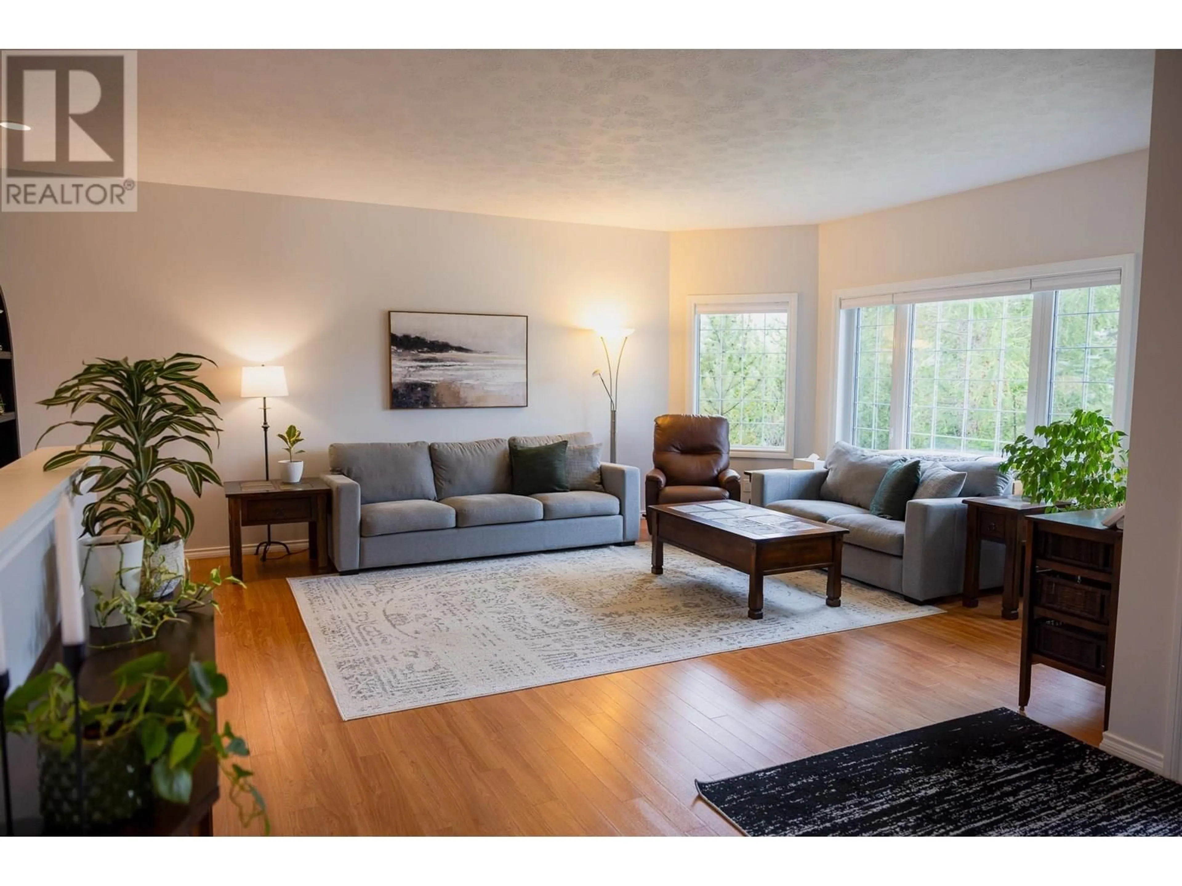 Living room with furniture, wood/laminate floor for 1812 110 AVENUE, Dawson Creek British Columbia V1G0A3